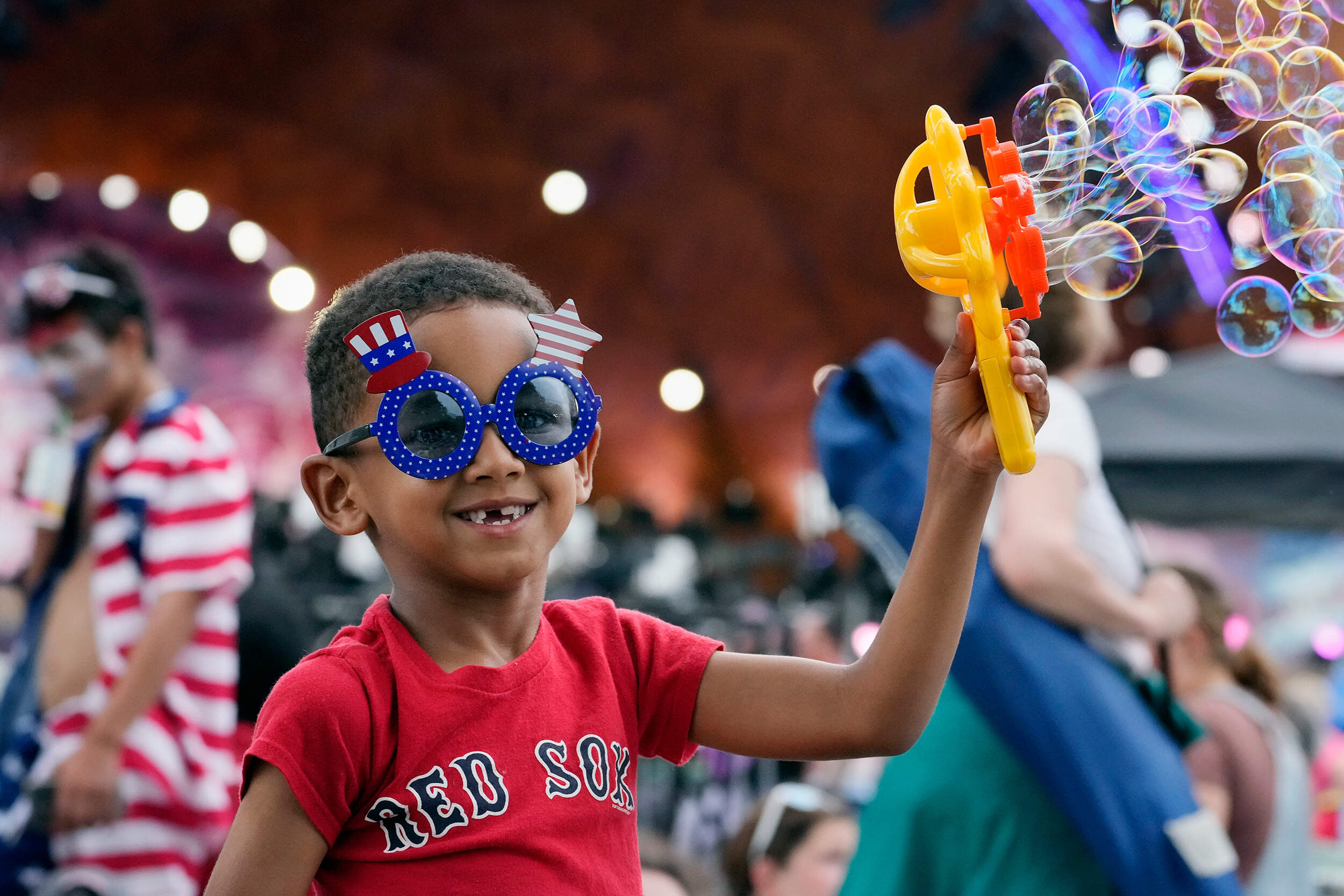 Damien Martinez-Hall, 6, makes soap bubbles while waiting for the start of the Boston Pops Fireworks Spectacular at the Hatch Memorial Shell. (Michael Dwyer/AP)