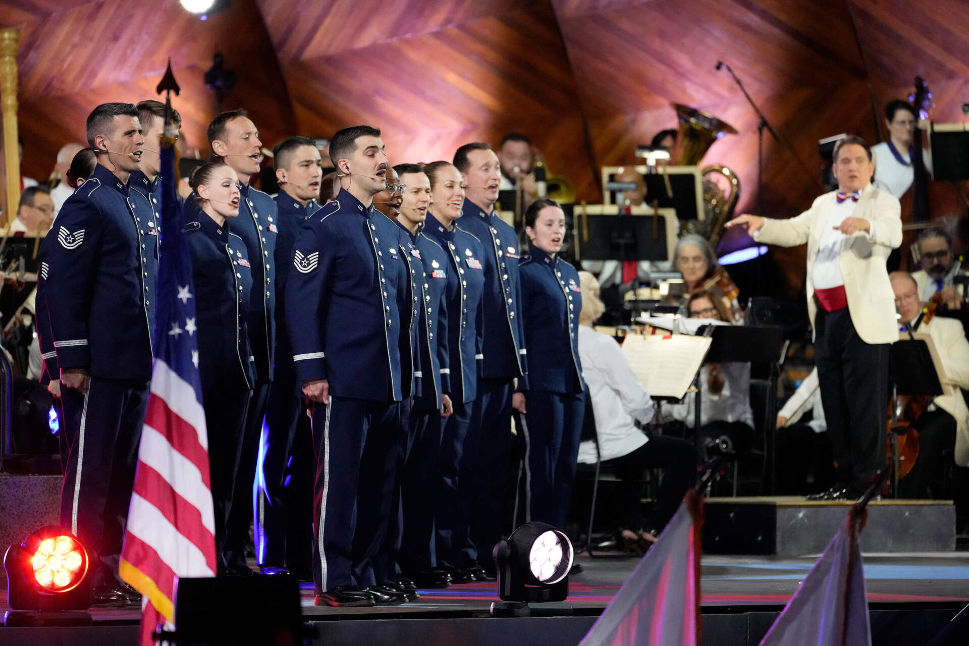 The Singing Sergeants sing the national anthem as Keith Lockhart, right, conducts during the Boston Pops. (Michael Dwyer/AP)