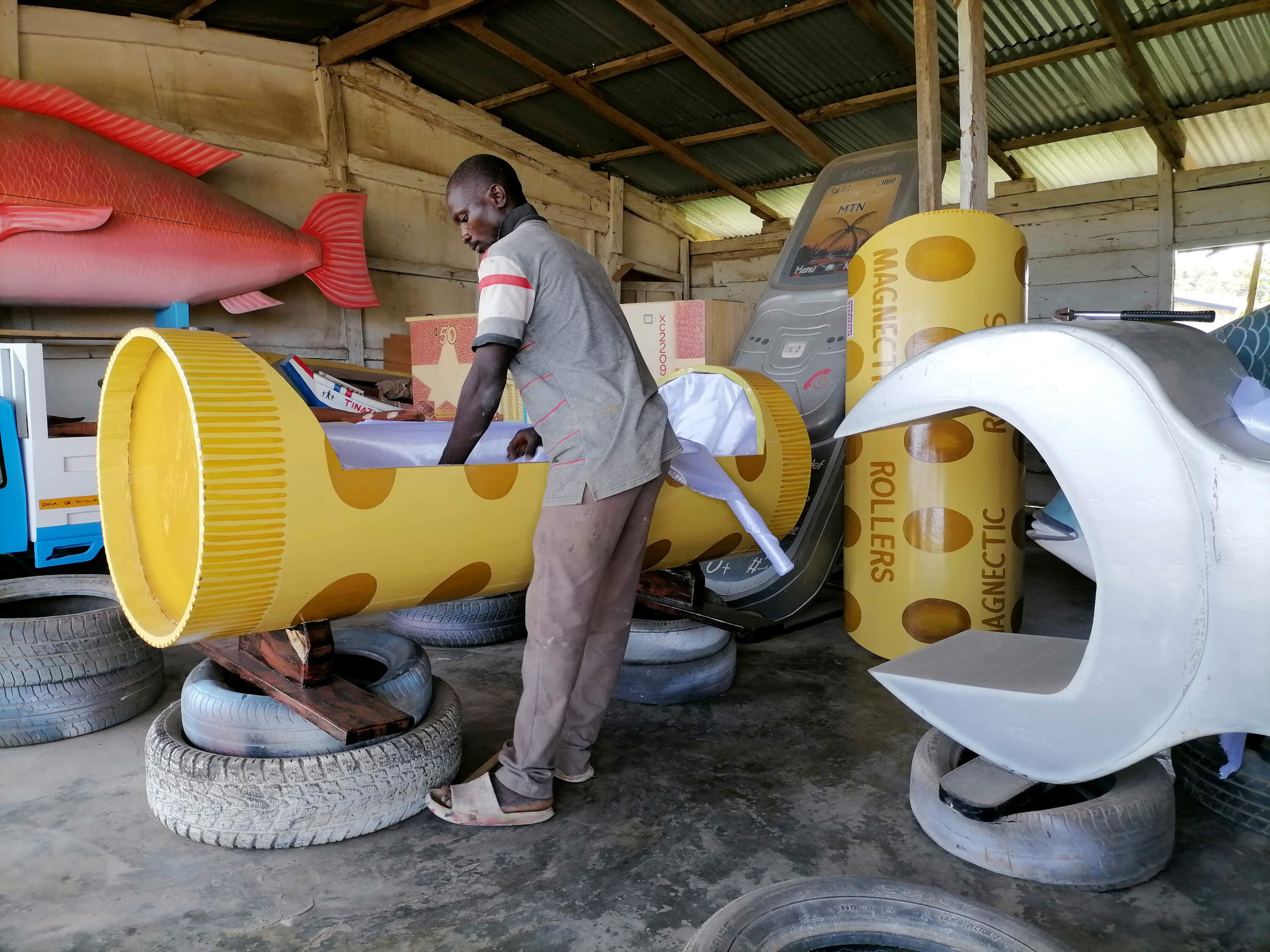 A carpenter works on a fantasy coffin, also known as figurative coffins, which are mostly used by locals living in southern Ghana for their religious beliefs about the afterlife. (Kwame Adzaho/Anadolu Agency via Getty Images)