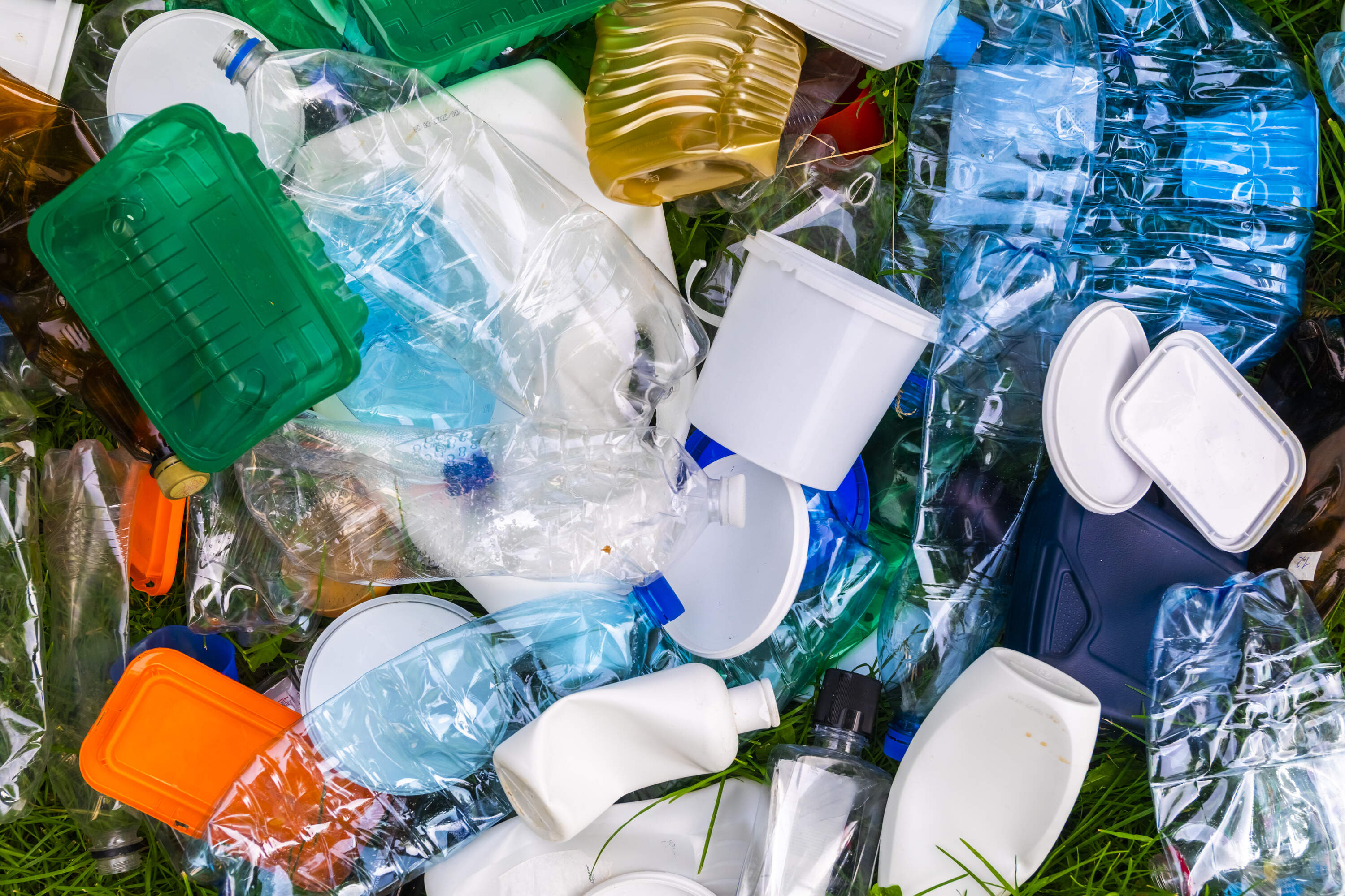 Various types of plastic trash on the grass. (Anton Petrus/Getty Images)