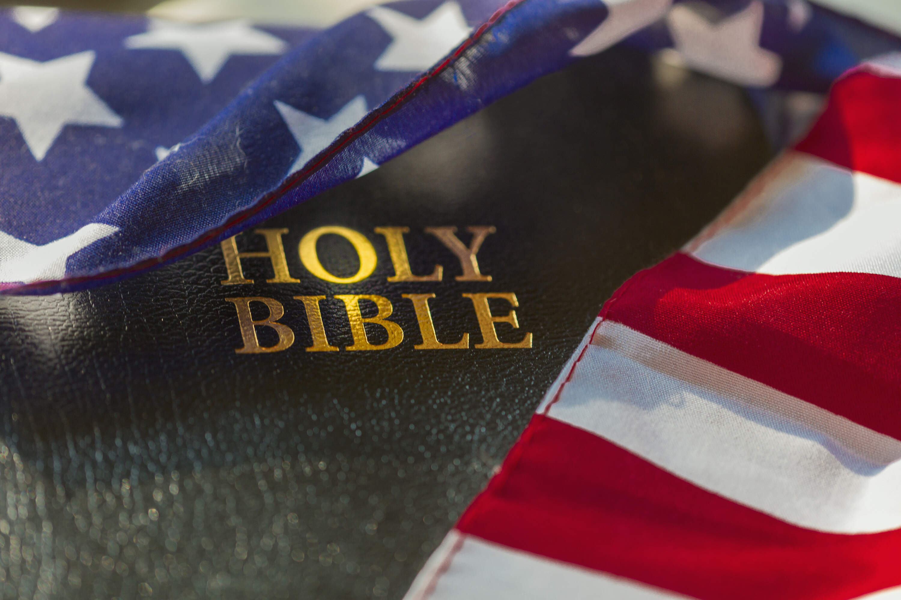 The Holy Bible is draped with an American flag. (Eric Raptosh/Getty Images)