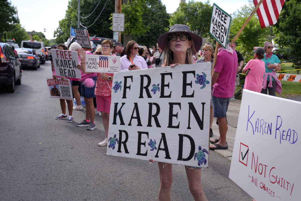 Jean Allan, of Weymouth, Mass., front, a supporter of Karen Read, displays a sign to passing cars near Norfolk Superior Court, Monday, July 1, 2024, in Dedham, Mass. (Steven Senne/AP)