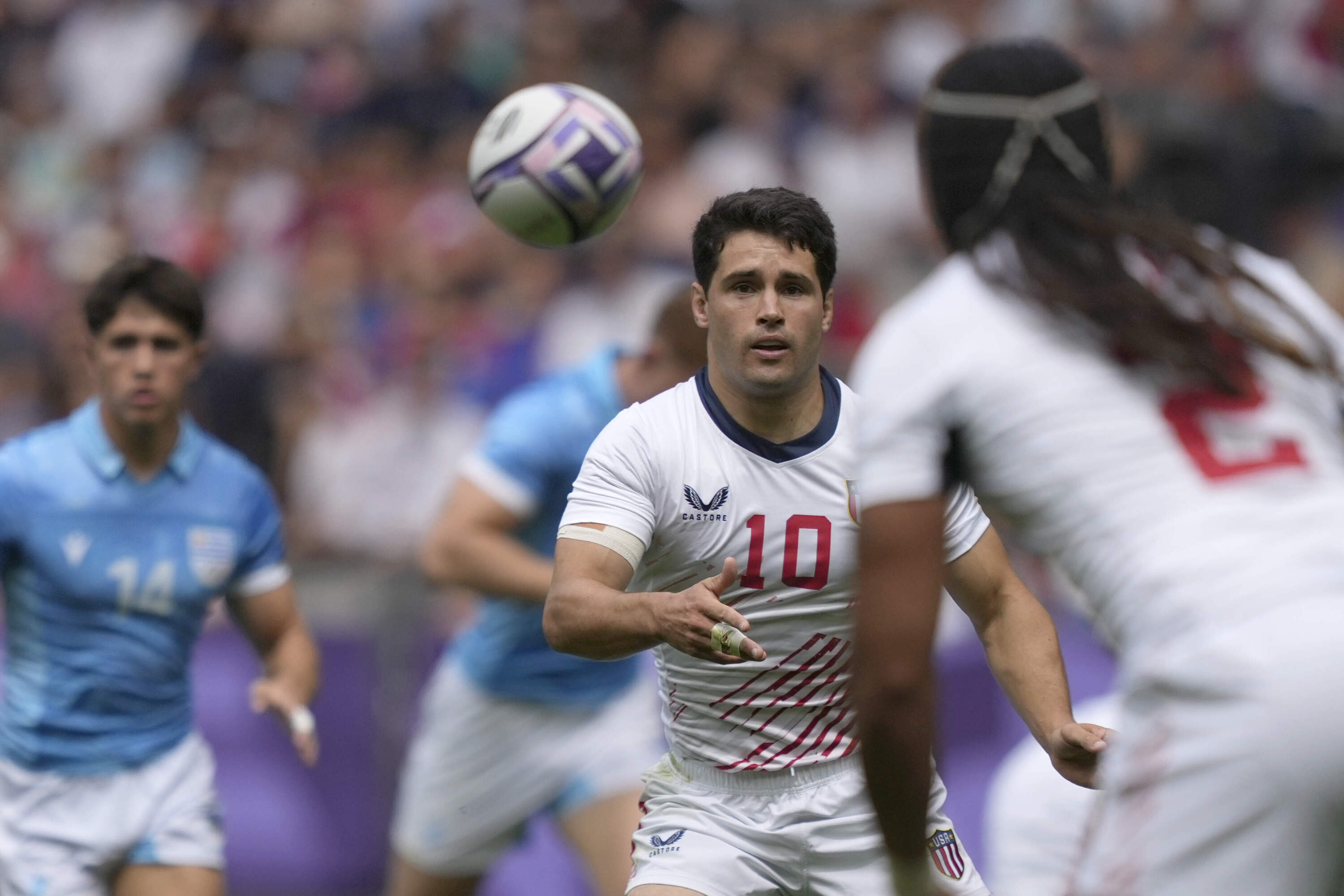 Madison Hughes passes the ball to United Sates teammate Make Unufe during the men's Rugby Sevens Pool C match against Uruguay at the 2024 Summer Olympics. (Tsvangirayi Mukwazhi/AP)