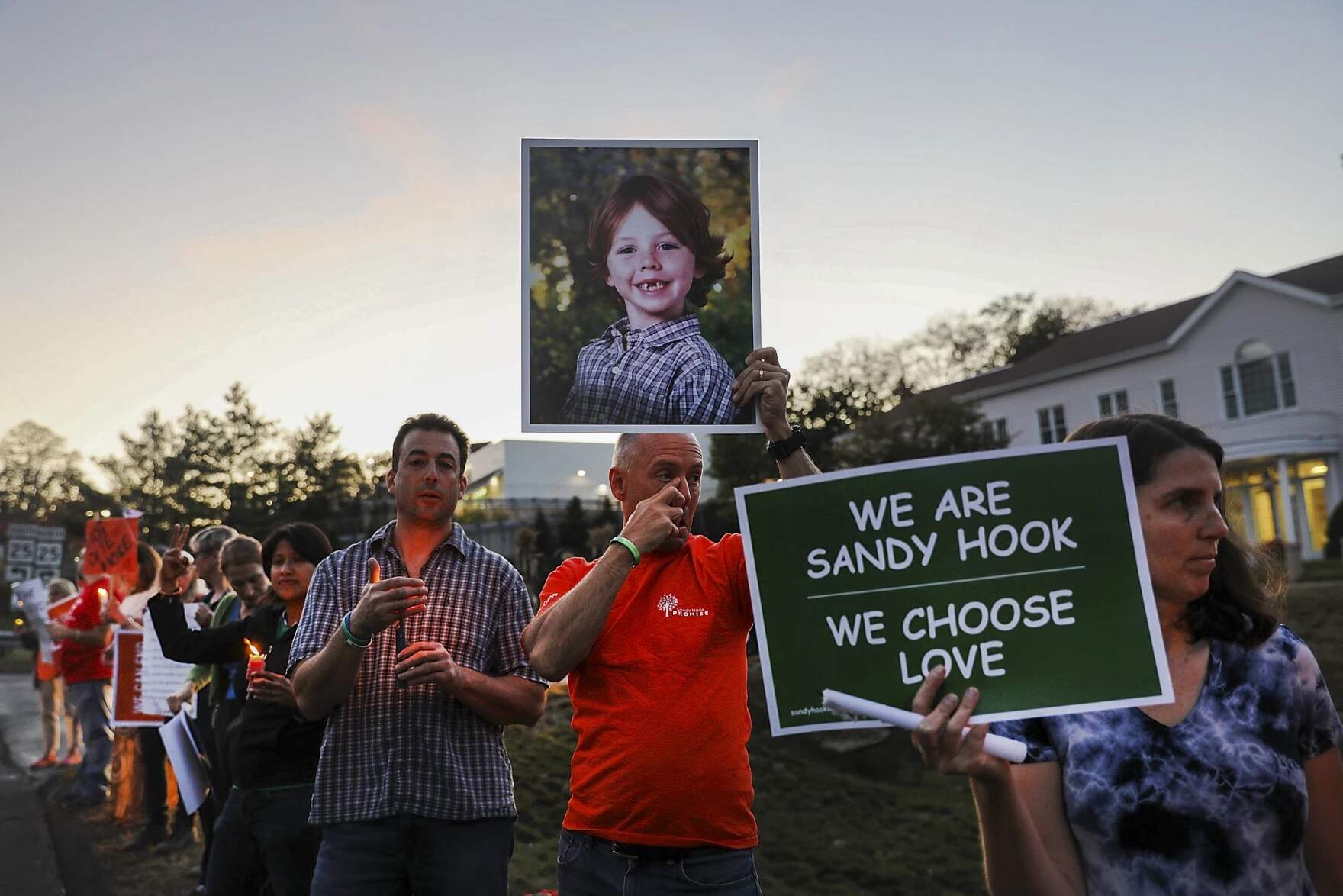 Mark Barden holds up a picture of his son Daniel who was killed in the Sandy Hook massacre during a vigil in 2017. (Spencer Platt/Getty via Connecticut Public Radio)