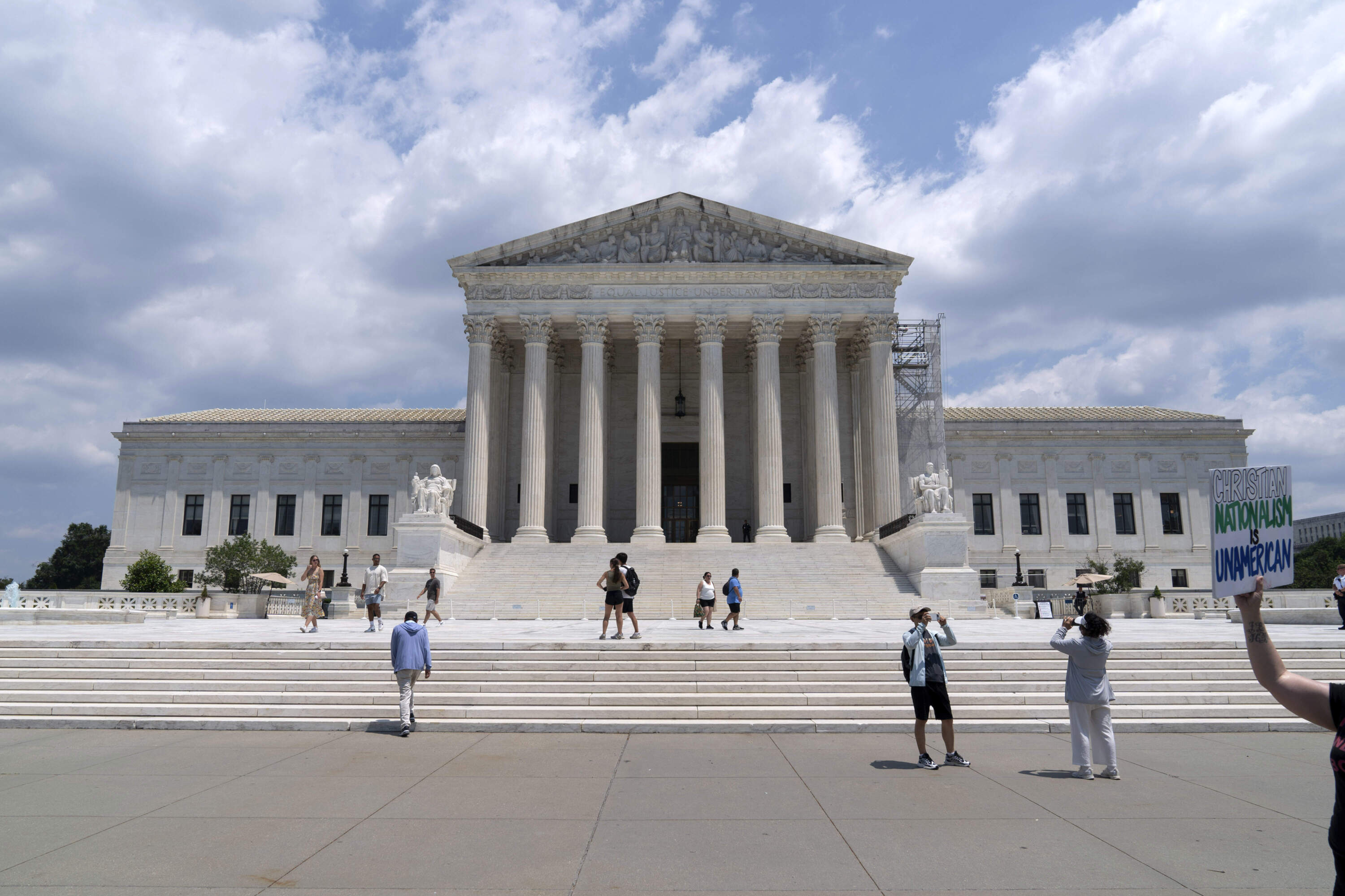 Visitors pose for photographs outside the U.S. Supreme Court Tuesday, June 18, 2024, in Washington. (Jose Luis Magana/AP)