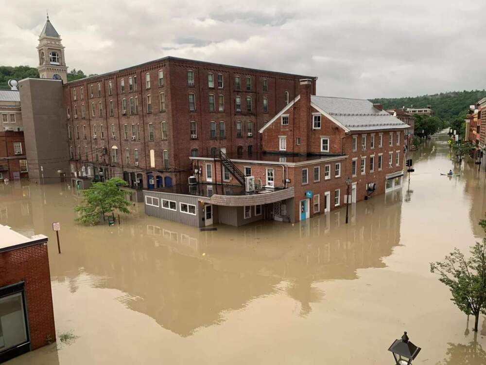 A person uses a kayak to navigate downtown Montpelier after flooding on July 11, 2023. City officials used an emergency health order to close the downtown area. (Mike Dougherty/Vermont Public)