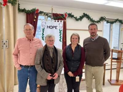 Flood recovery caseworker Sherry Marcelino, third from left, alongside United Community Church of Johnson board member Sidney Nichols, Rev. Wendy Jane Summers, and Greg Stefanski with the Lamoille Area Recovery Network, from left, pictured in December 2023. (Peter Hirschfeld/Vermont Public)