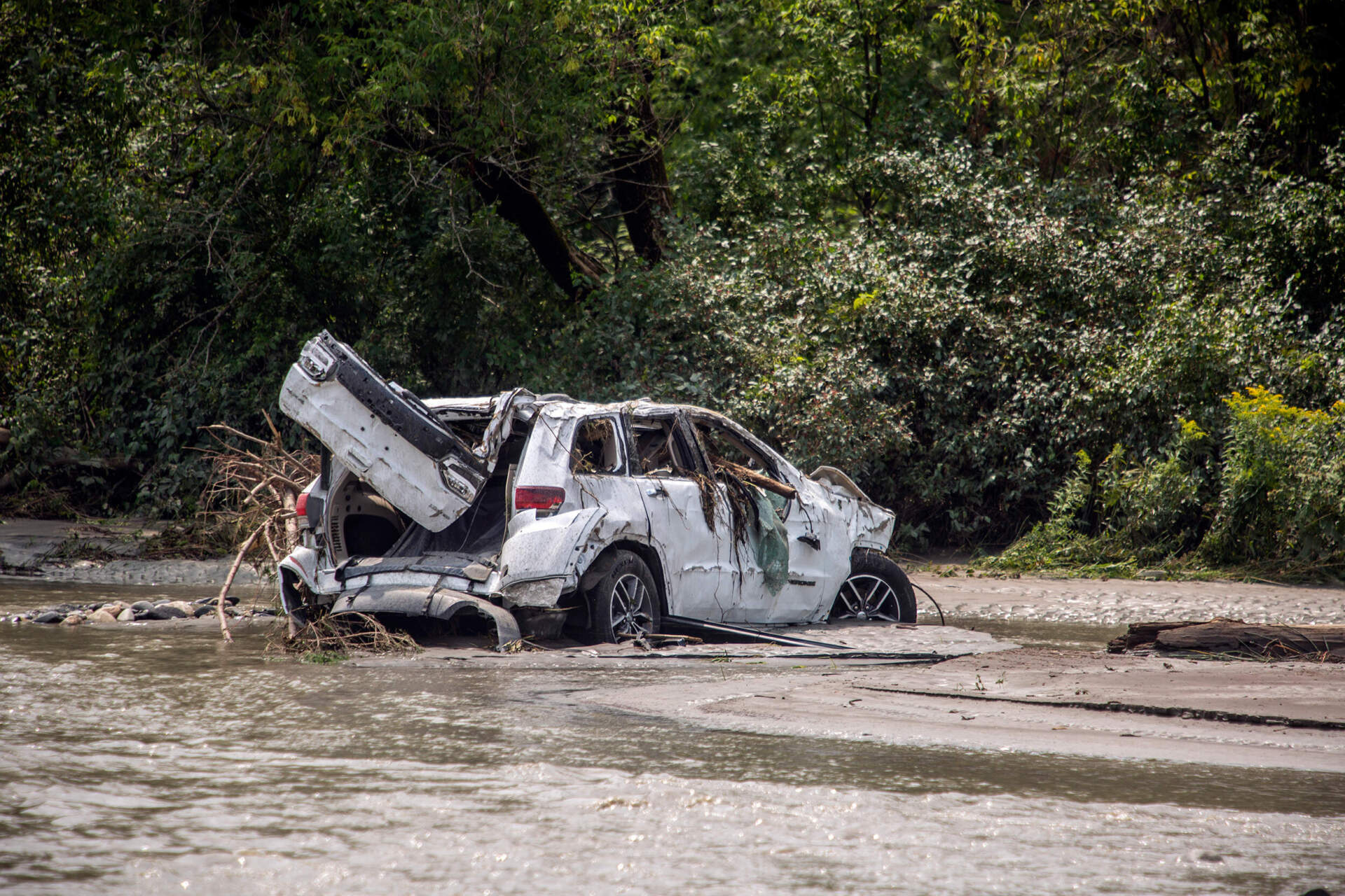 A damaged car sits amid flood debris in Lyndon, Vt., Tuesday, July 30, 2024. (Dmitry Belyakov/AP)