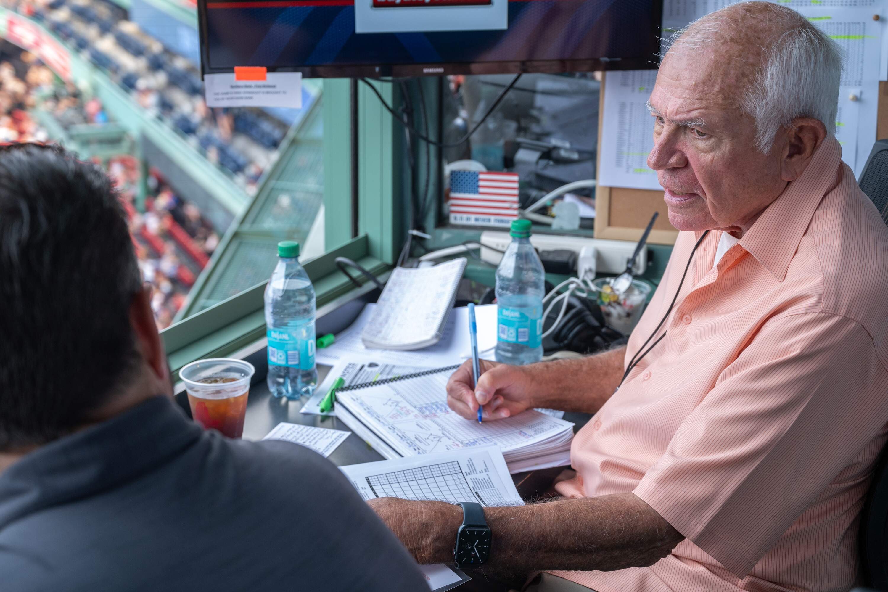 Joe Castiglione and Lou Merloni prepare for the start of the Red Sox game against the Blue Jays at Fenway Park. (Sharon Brody/WBUR)