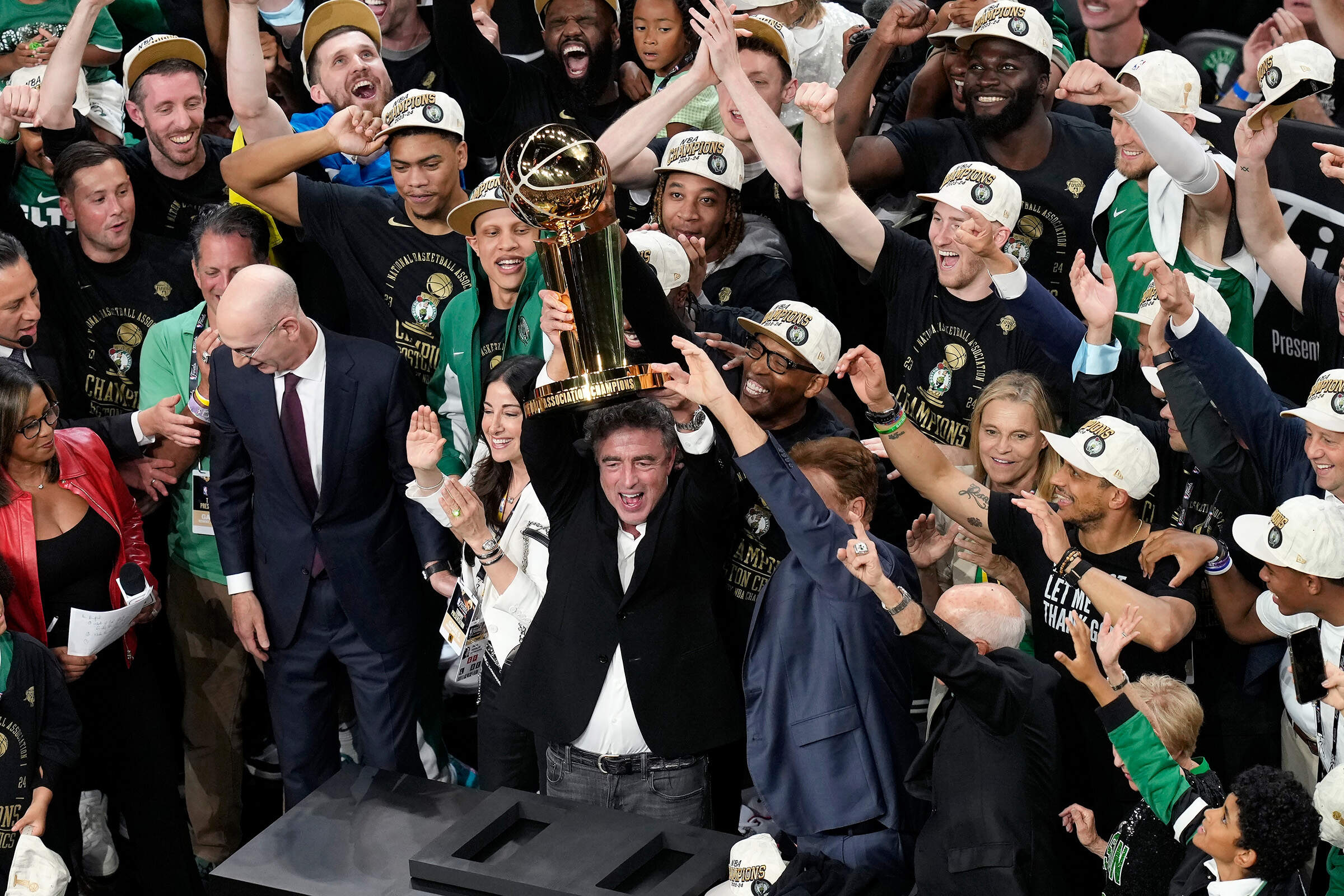 Boston Celtics owner Wyc Grousbeck raises the trophy after defeating the Dallas Mavericks in Game 5 of the NBA basketball finals on June 17, 2024, in Boston. (Michael Dwyer/AP)