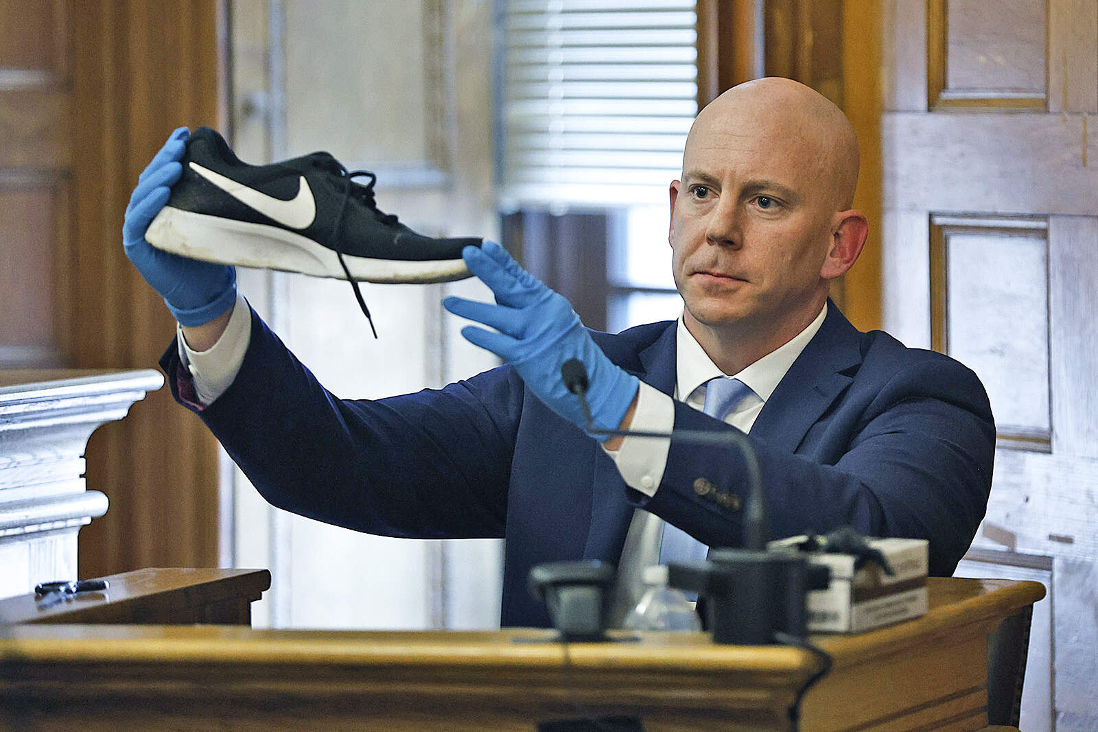 Massachusetts State Police Detective Lt. Brian Tully holds up a piece of evidence on the witness stand in Karen Read's murder trial on June 12 in Norfolk Super Court in Dedham, Mass. (Greg Derr/The Patriot Ledger via AP pool file photo)