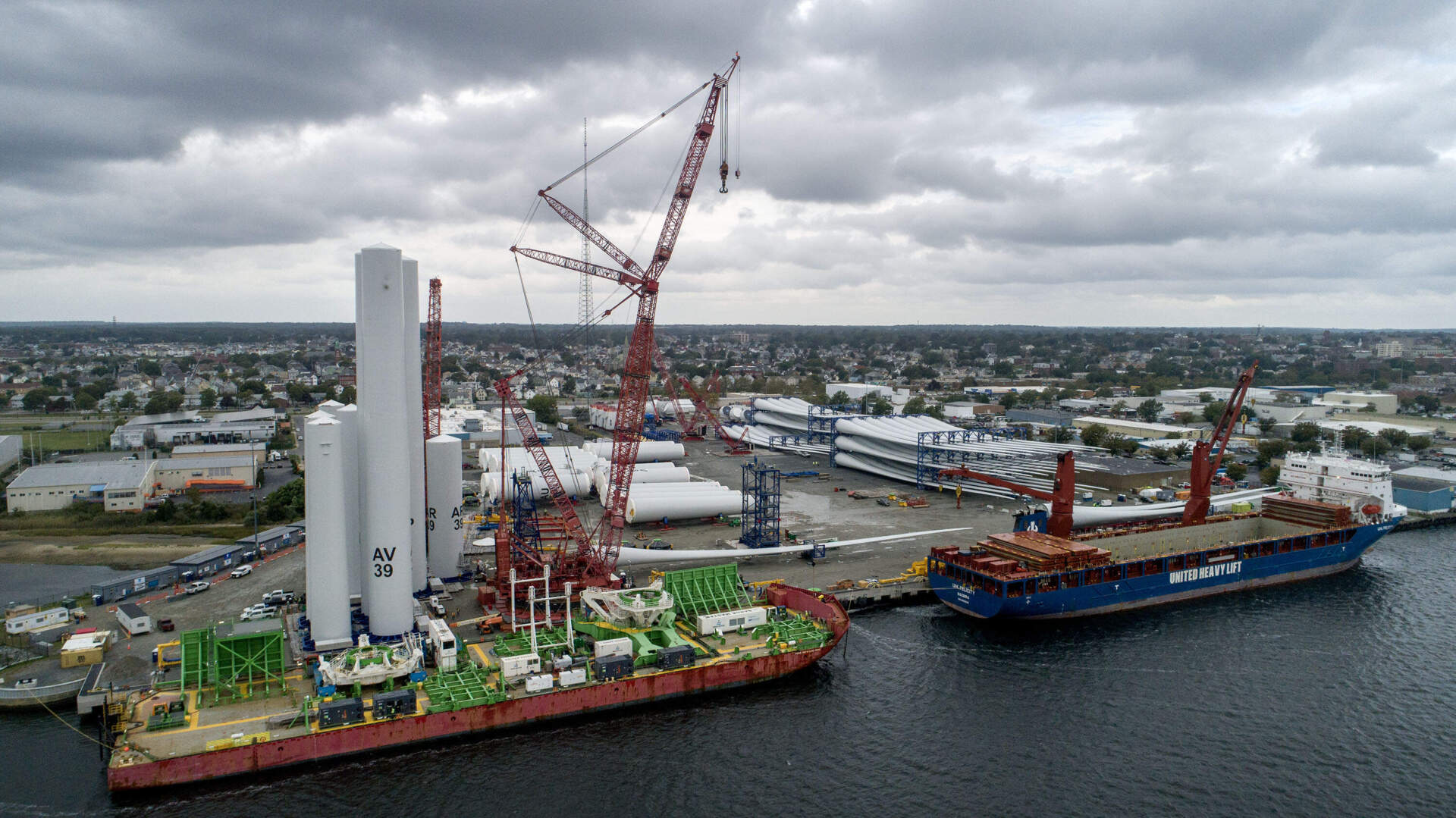 Wind turbine components are organized on the dock at New Bedford Marine Commerce Terminal to be shipped to their destinations off Martha's Vineyard, where they will be assembled at sea. (Robin Lubbock/WBUR)