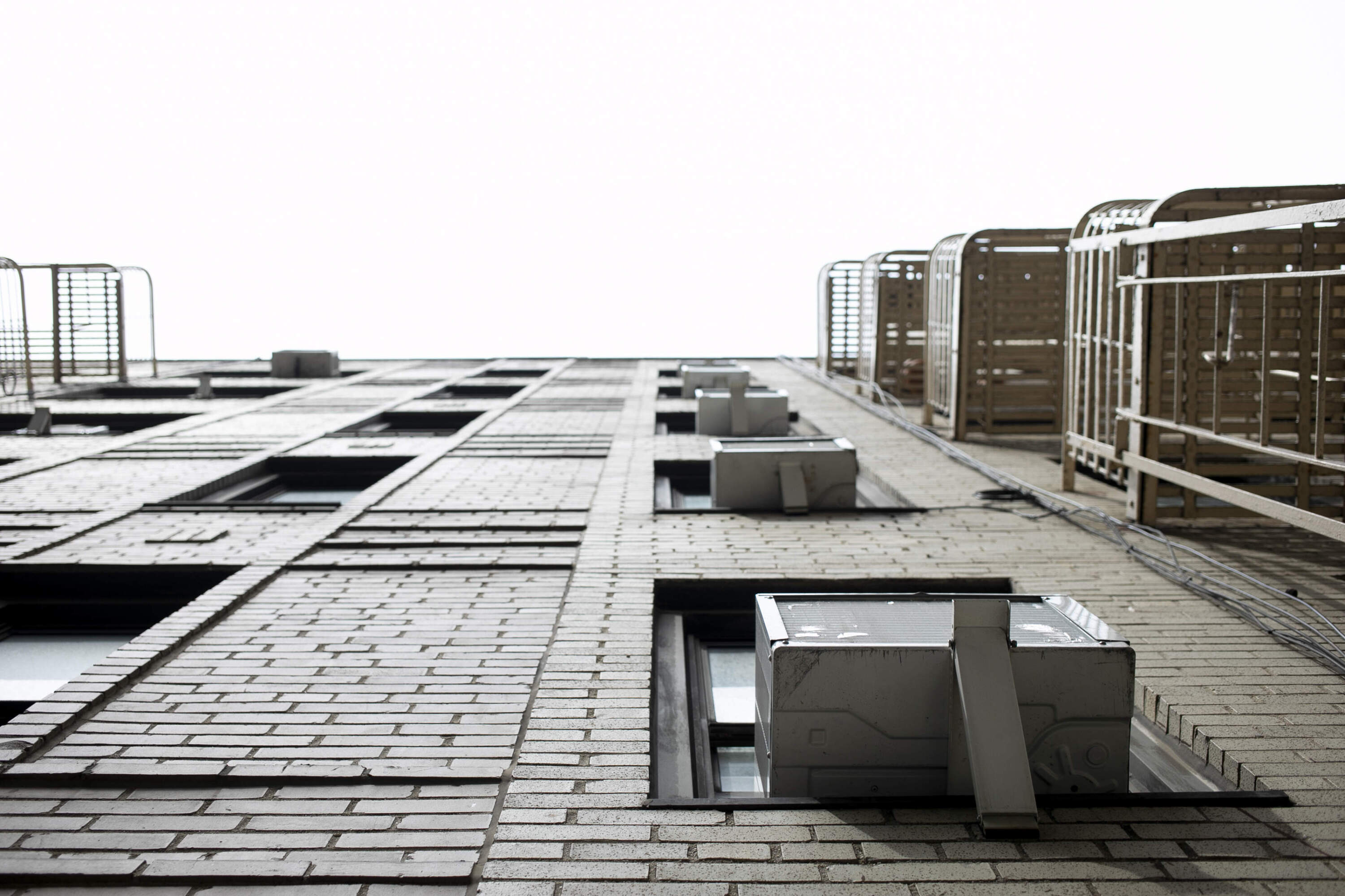 Window air conditioning units sit in windows in New York. (Jenny Kane/AP)