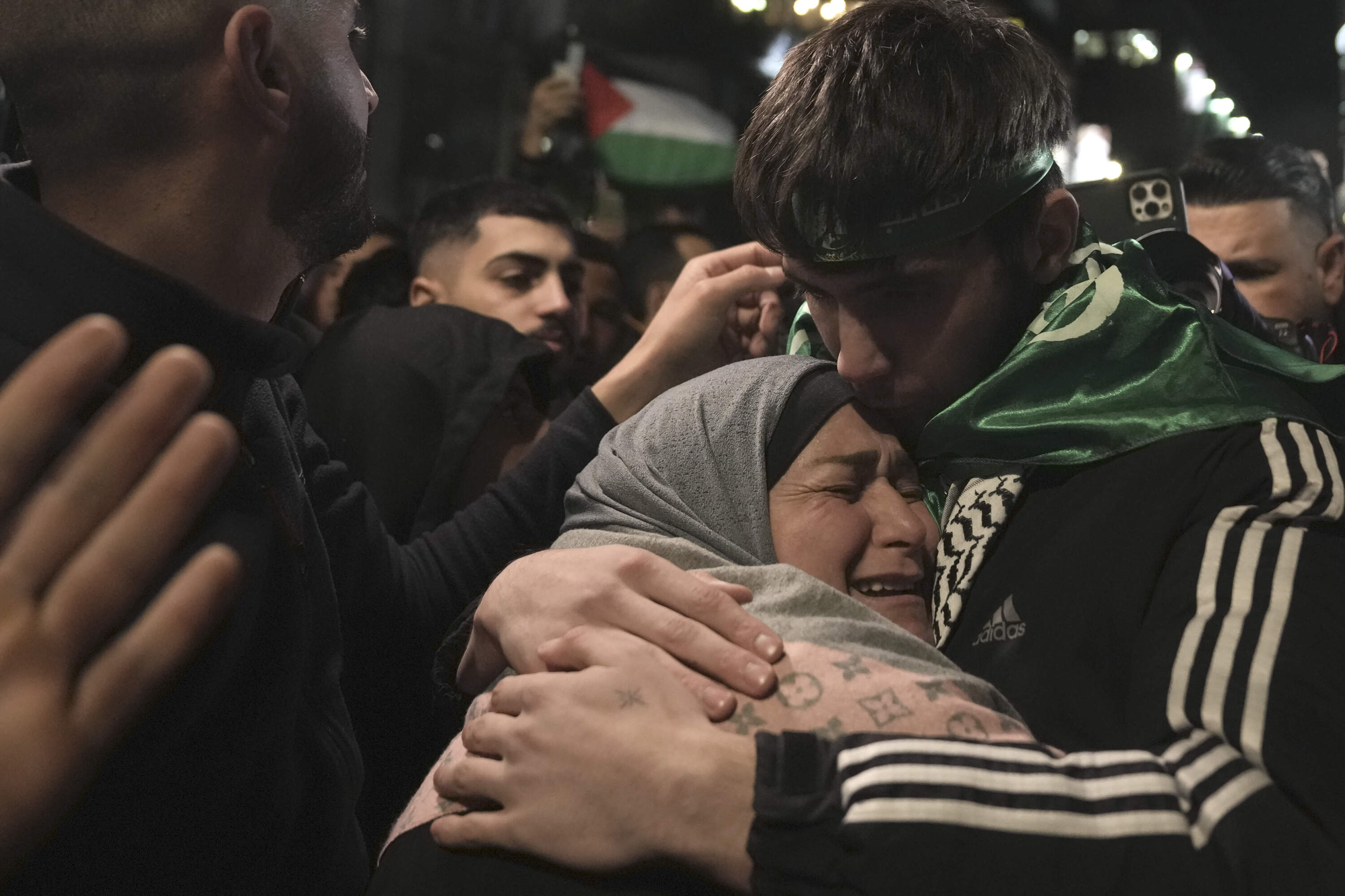 Omar Atshan, 17, is hugged by his mother after being released from an Israeli prison in the West Bank town of Ramallah, Sunday Nov. 26, 2023. (Nasser Nasser/AP)