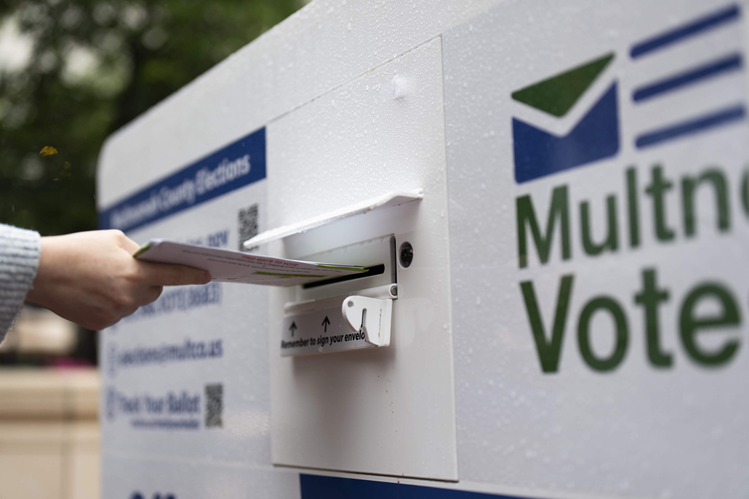 FILE - A person drops off a vote-by-mail ballot at a dropbox in Pioneer Square during primary voting on May 21, 2024, in Portland, Ore. (Jenny Kane/AP)