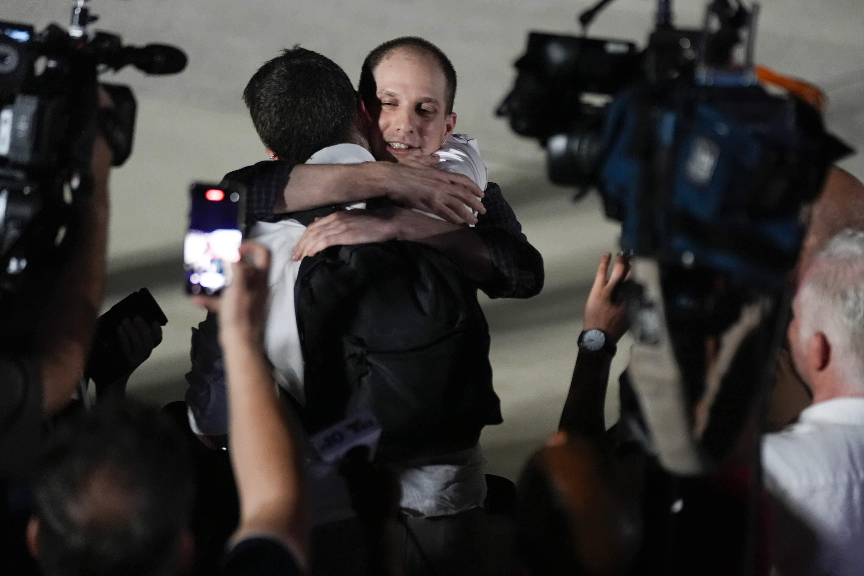 Reporter Evan Gershkovich receives an embrace from a colleague following his release as part of a 24-person prisoner swap between Russia and the United States on Thursday, Aug. 1, 2024. (Manuel Balce Ceneta/AP)