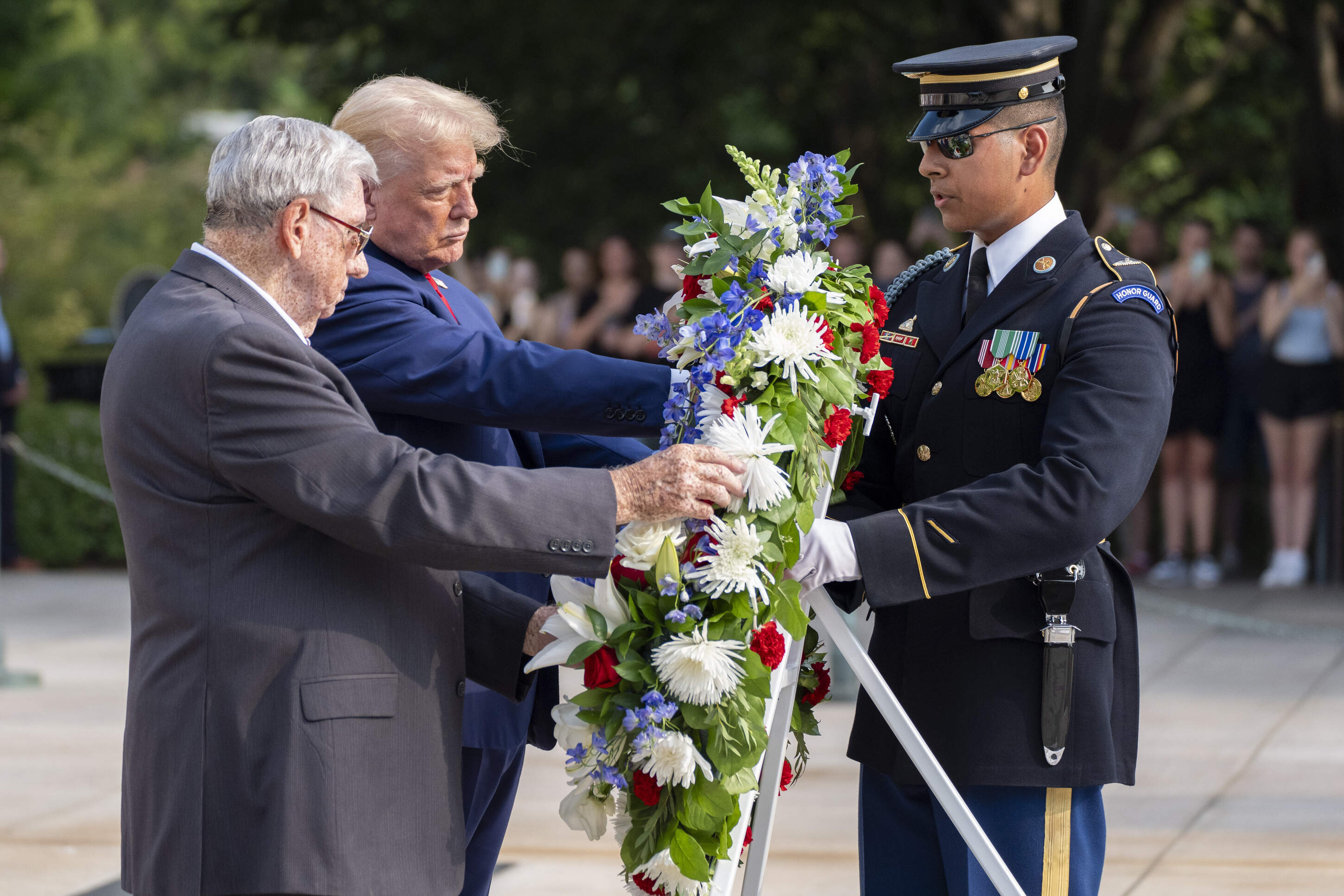 Bill Barnett, left, grandfather of Darin Taylor Hoover, and Republican presidential nominee former President Donald Trump place a wreath at the Tomb of the Unknown Solider in honor of Staff Sgt. Darin Taylor Hoover at Arlington National Cemetery, Monday, Aug. 26, 2024, in Arlington, Va. (Alex Brandon/AP)