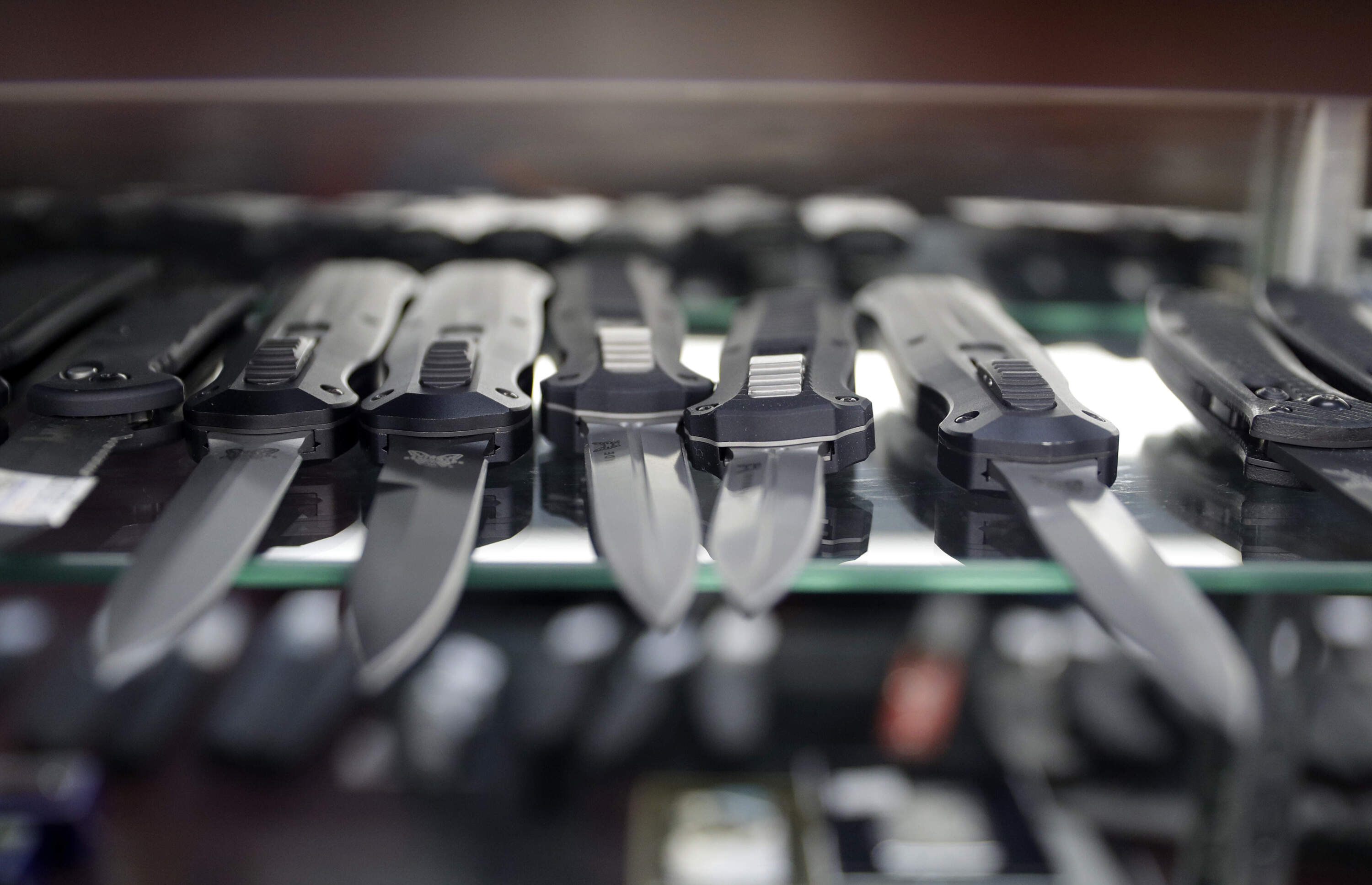 Switchblade knives is a display case. (John Locher/AP)