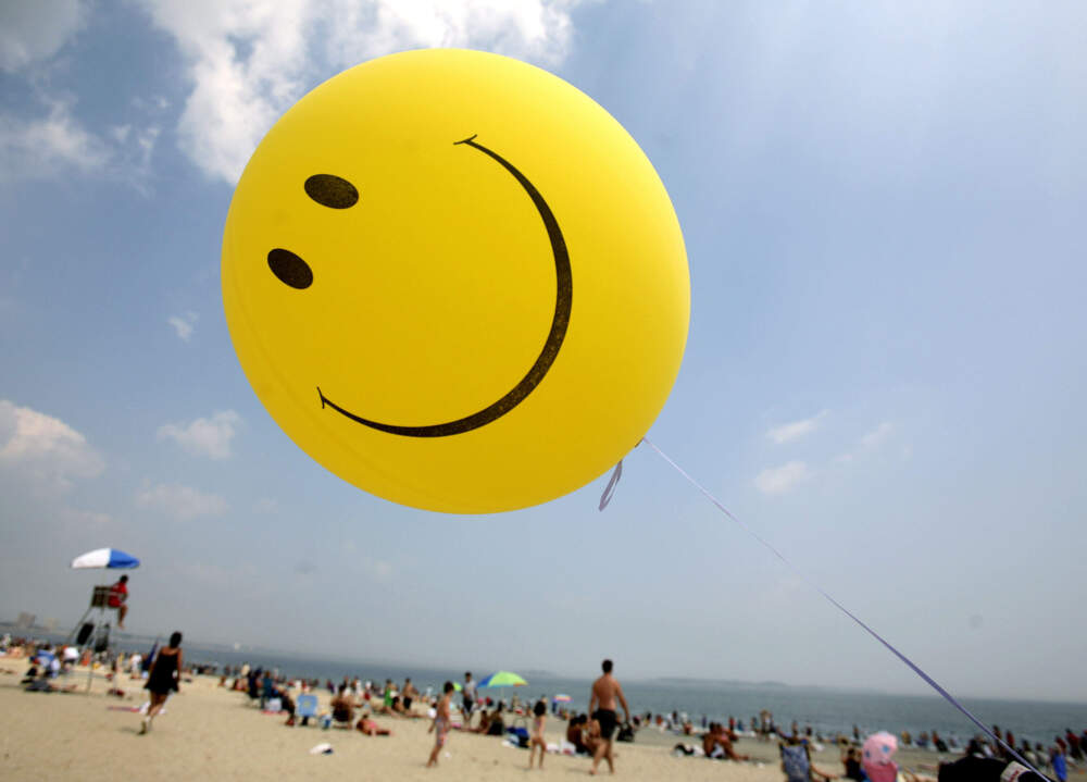 A smiley face balloon floats over Revere Beach in Revere, Mass. (Michael Dwyer/AP)