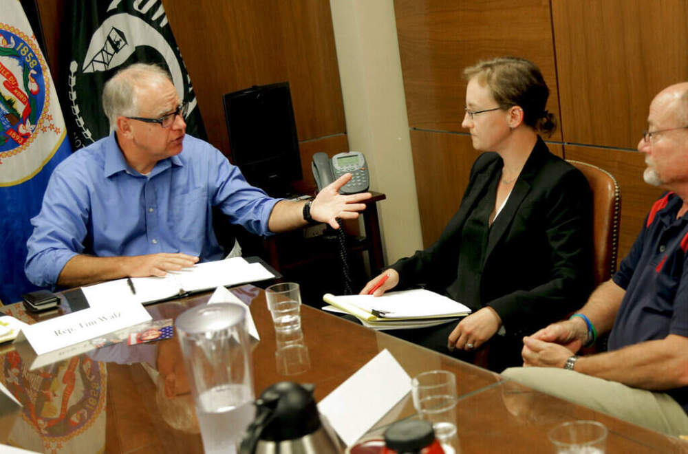 Then Rep. Tim Walz, D-Minn., left, talks with Melissa Houghtaling, center, during a roundtable, Thursday, Aug. 14, 2014 in St. Paul, Minn. to discuss ways to improve mental health for veterans and stop the rash of suicides. (Jim Mone/AP)