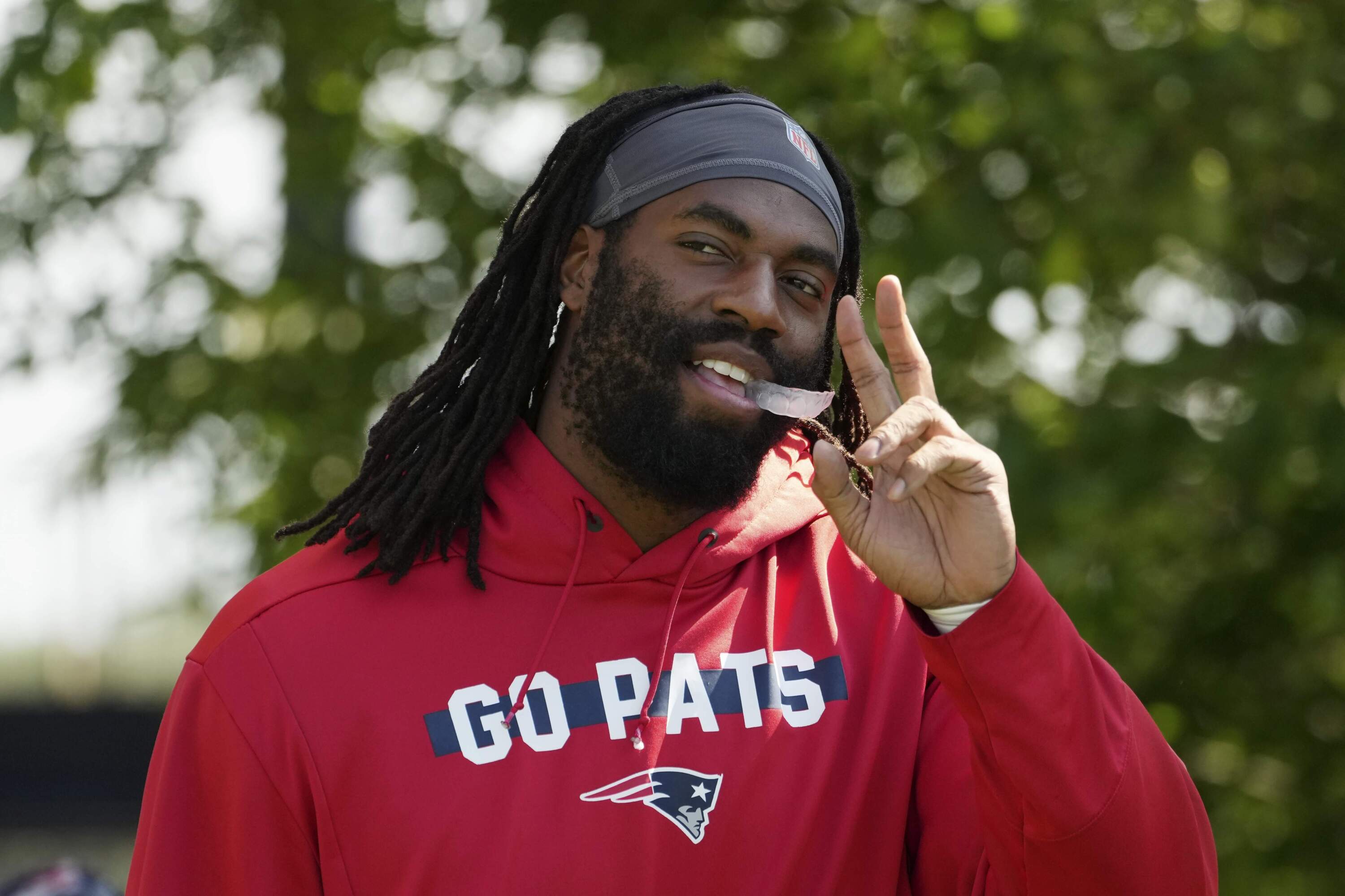 Matthew Judon walks onto the field during football practice, Tuesday, Aug. 13, 2024, in Foxborough, Mass. (Michael Dwyer/AP)