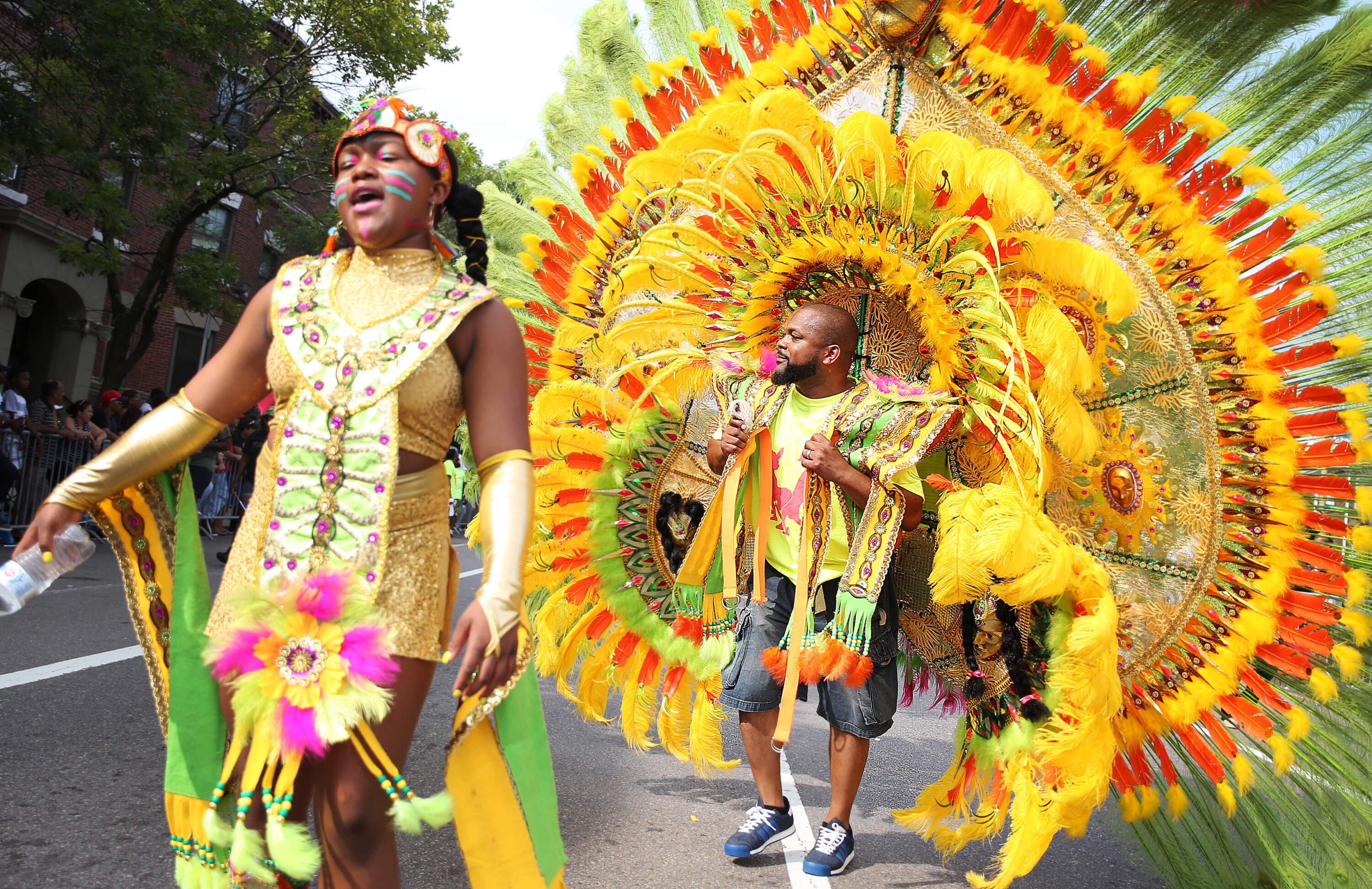 Cierra Niles, left, dances with her father Joell during Boston's 45th annual Carnival parade, which celebrates the Caribbean community with costumes, floats and dancing, on Aug. 25, 2018. (Erin Clark/The Boston Globe via Getty Images)