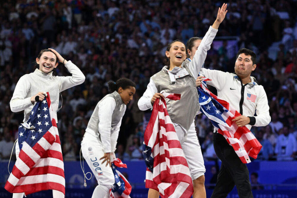 Lee Kiefer, Lauren Scruggs, Maia Mei Weintraub and Jacqueline Dubrovich of Team United States celebrate their gold medals at the end of the Women's Foil Team final on day six of the Olympic Games Paris 2024 at Grand Palais on August 01, 2024 in Paris, France. (Photo by Image Photo Agency/Getty Images)