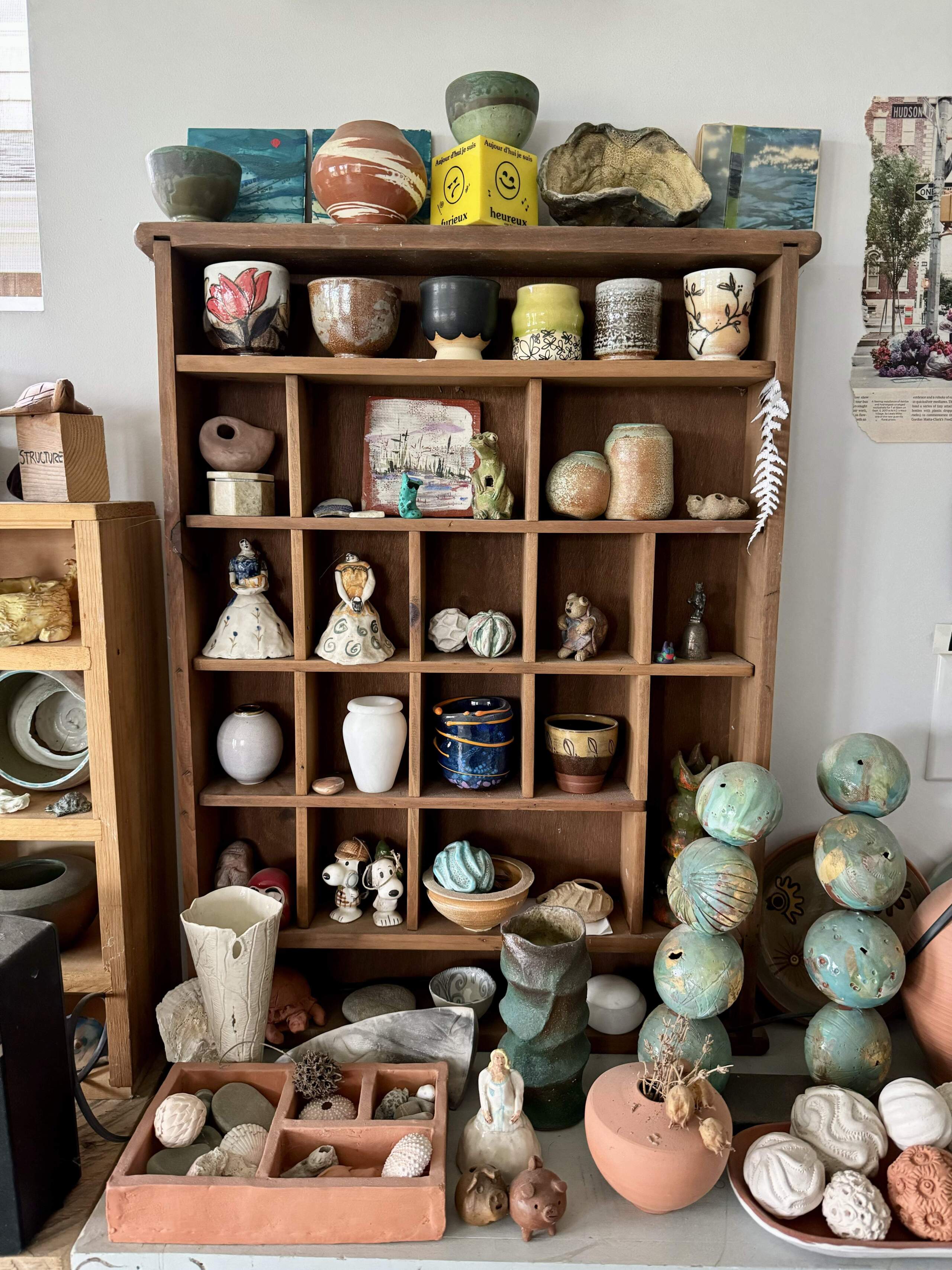 Cali Almy’s cabinet of small ceramics sits in her studio for inspiration. (Photo by Maddie Browning)