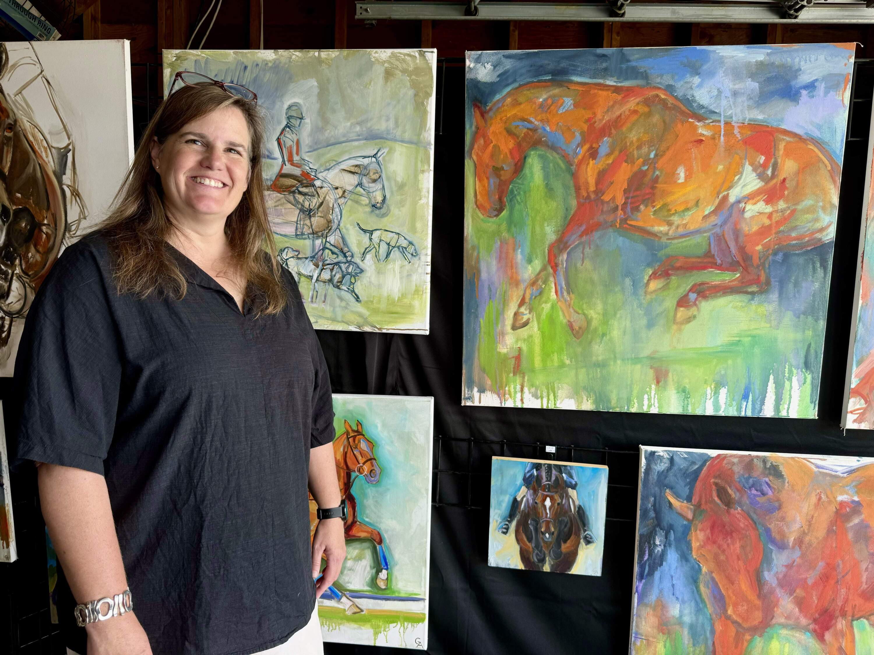Gretchen Almy with some of her work from her mother’s garage in Westport. (Photo by Maddie Browning)