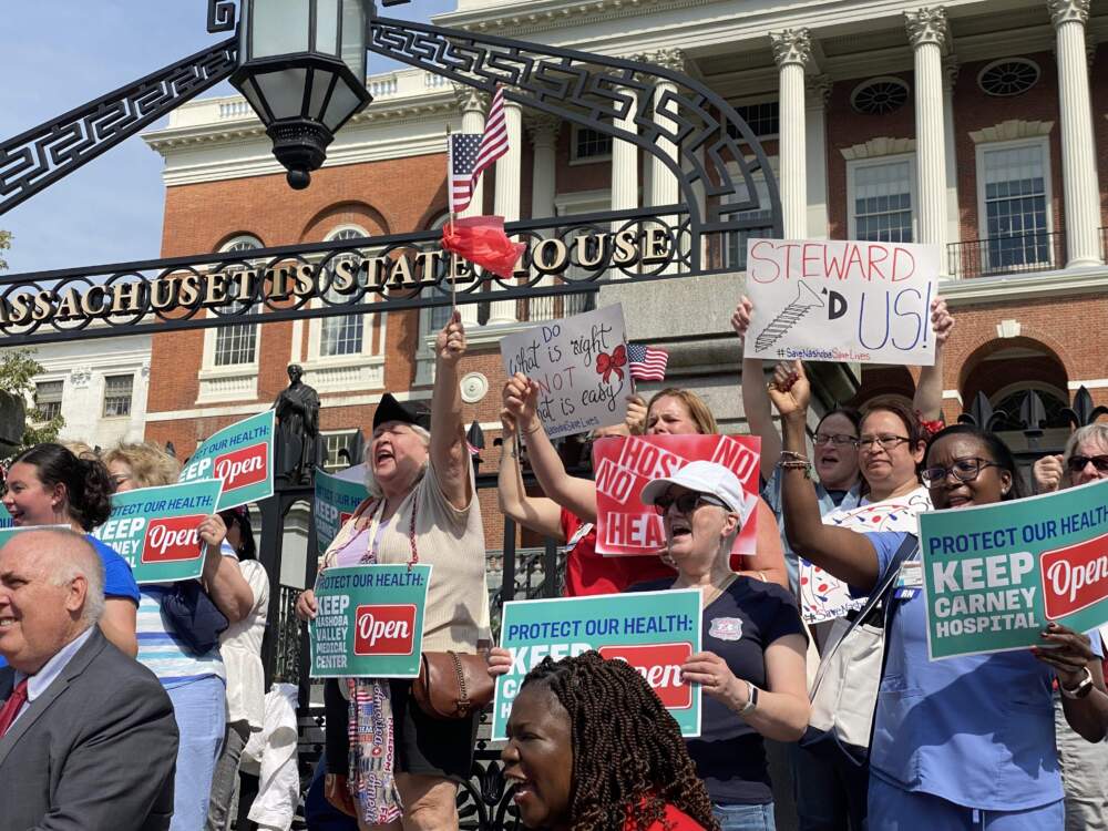 Protesters rally outside the State House calling to keep Carney Hospital open. (Miriam Wasser/WBUR)