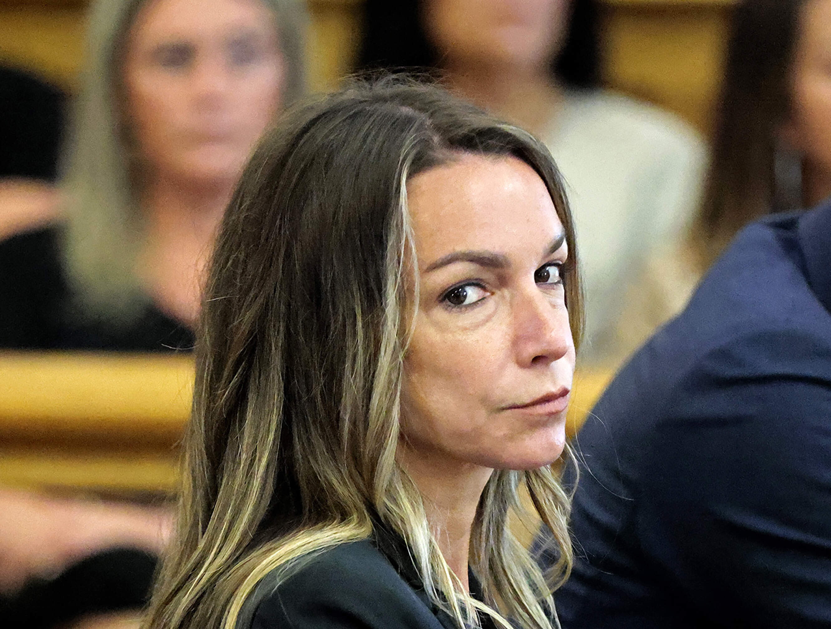 Karen Read looks toward the jurors, as they are greeted by Judge Beverly J. Cannone during her trial at Norfolk Superior Court in Dedham, Mass., Monday, July 1, 2024. (Pat Greenhouse/The Boston Globe via AP, Pool)