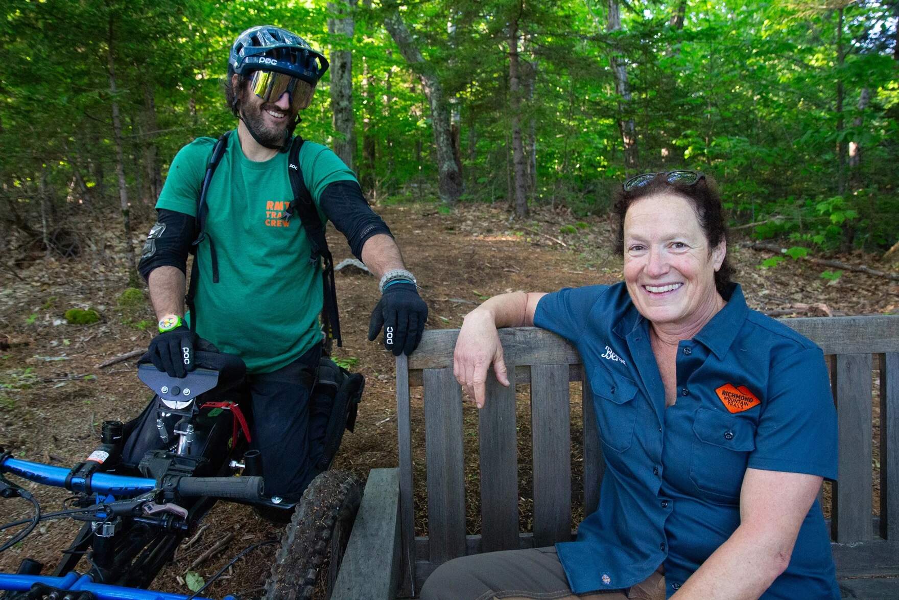 Greg Durso and Berne Broudy sit for a portrait at the top of the Driving Range trail network in Bolton. (Elodie Reed/Vermont Public)