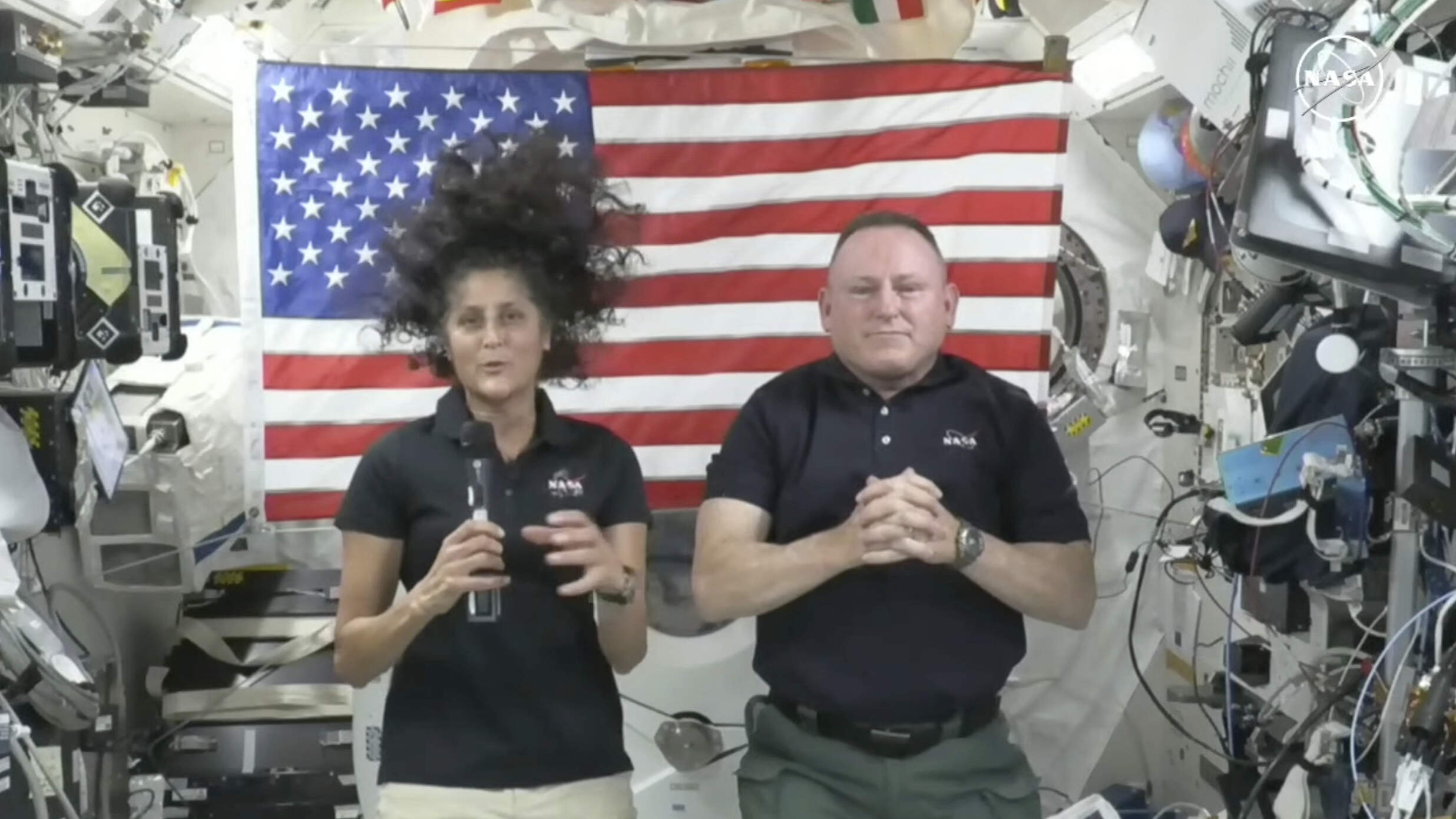 In this image from video provided by NASA, astronauts Suni Williams, left, and Butch Wilmore give a news conference aboard the International Space Station on July 10. (NASA via AP)