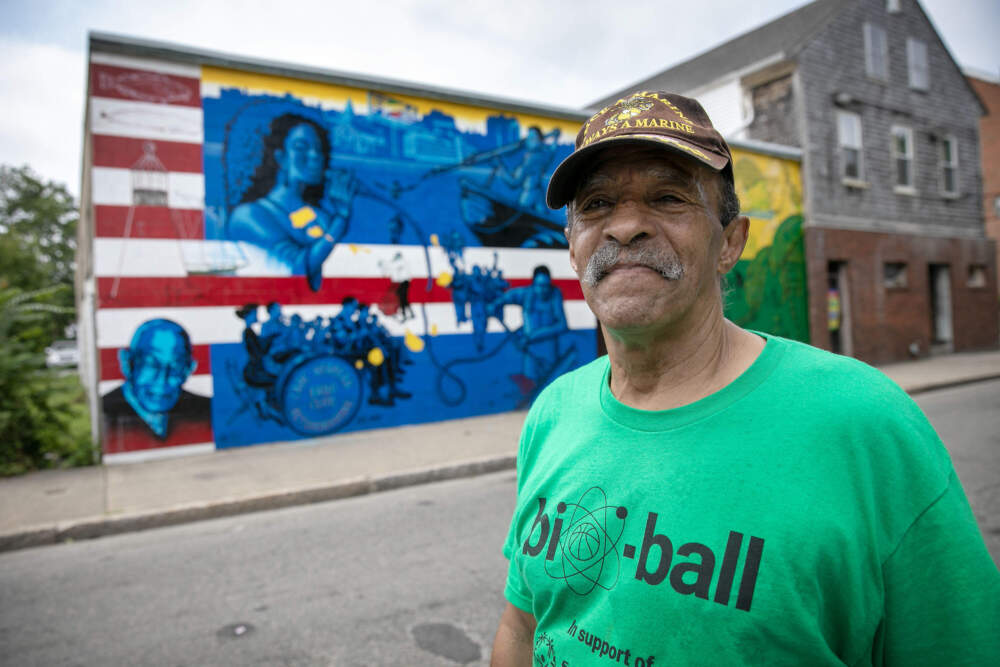 New Bedford community activist John “Buddy” Andrade, by a mural on Acushnet Avenue. (Robin Lubbock/WBUR)