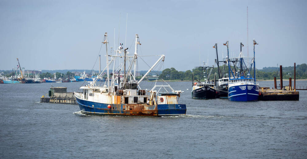 A fishing boat moves up the Acushnet River in New Bedford. (Robin Lubbock/WBUR)