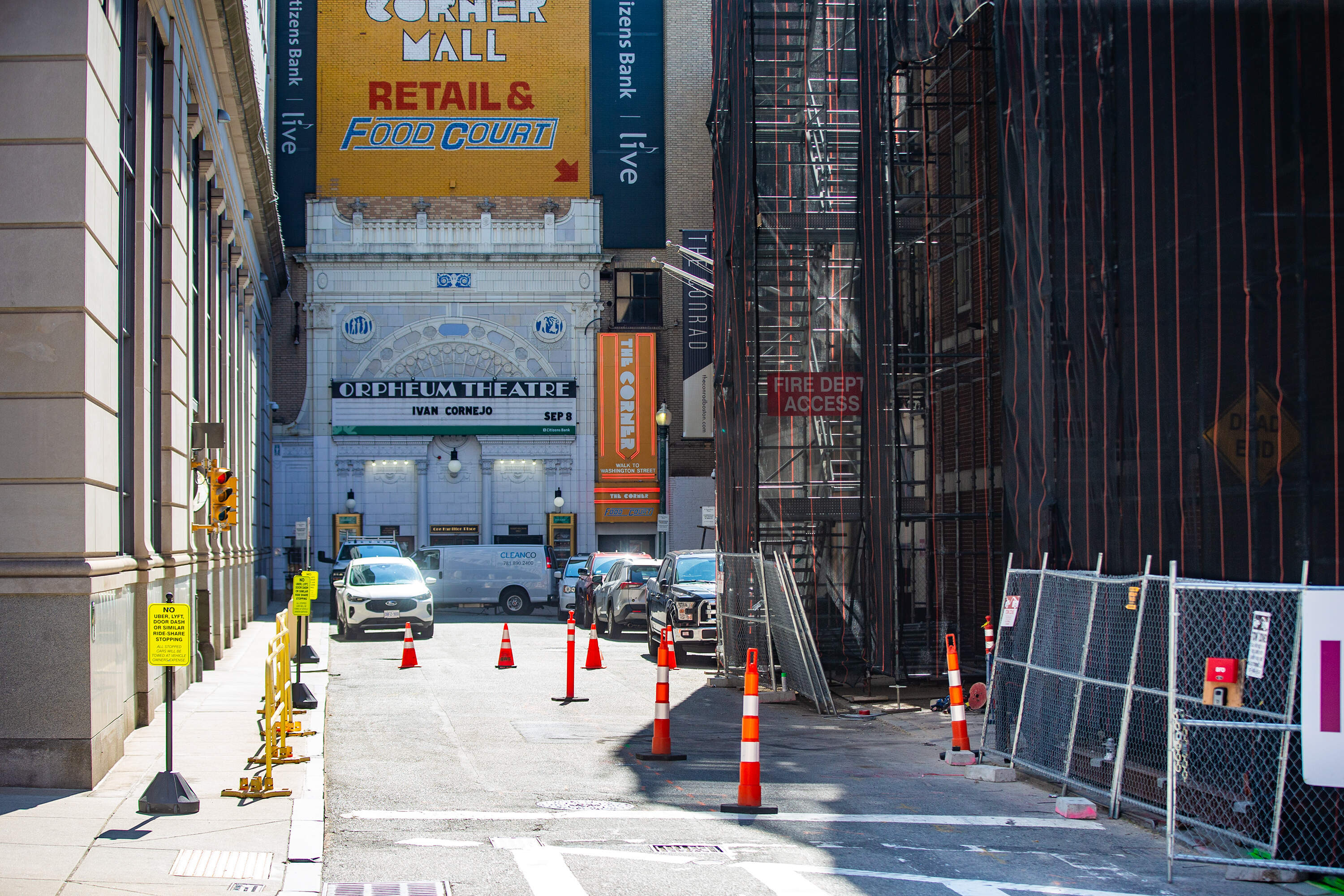 The Orpheum Theatre entrance sits beyond scaffolding on the side of the Holocaust Museum on Hamilton Street in Boston. (Jesse Costa/WBUR)