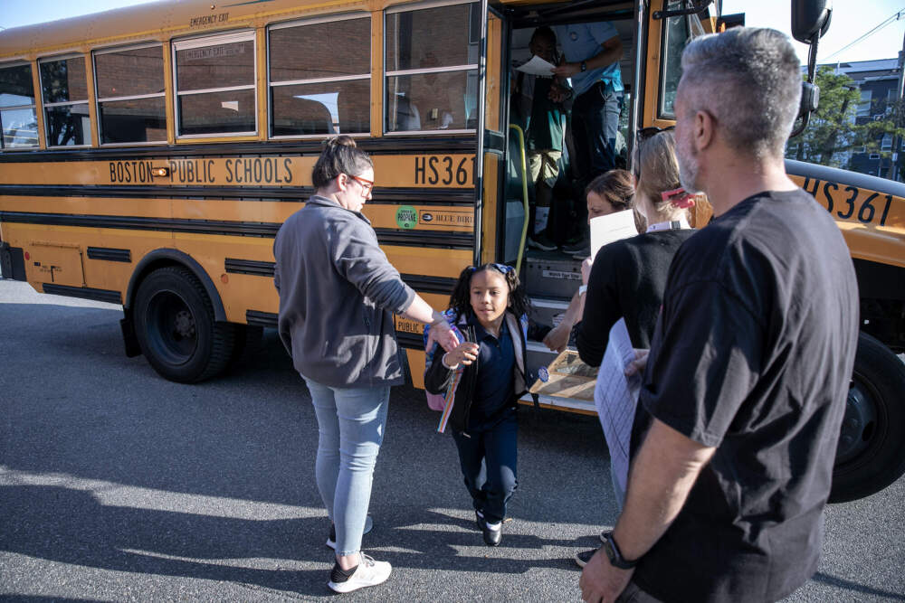 A student runs into Lee Elementary in Dorchester on the first day of the school year. (Robin Lubbock/WBUR)