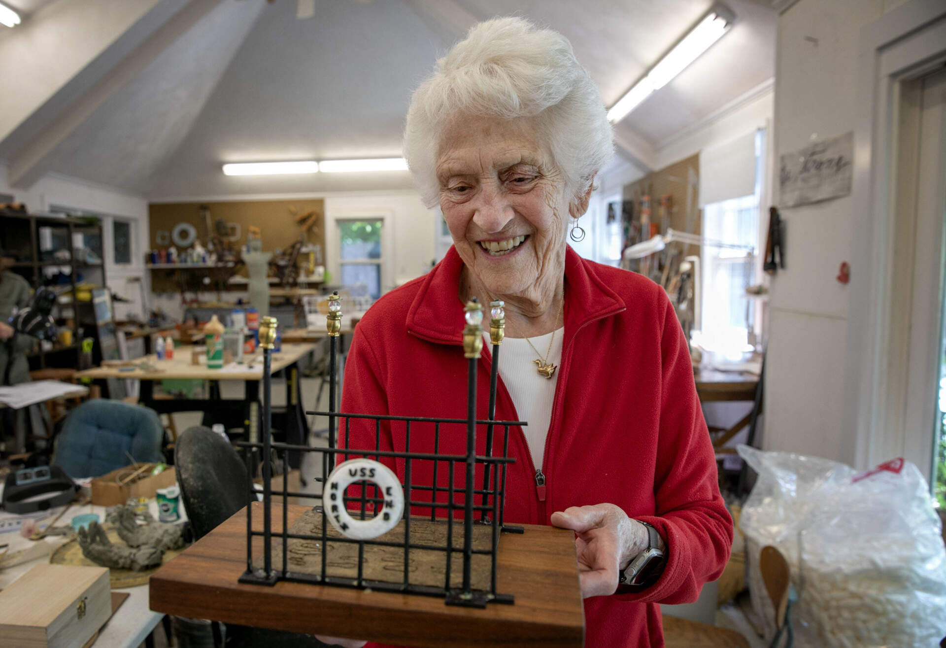 In her studio, Nancy Schön looks at the model of "The Noble Journey" that will be at St. Leonard's church in Boston's North End. (Robin Lubbock/WBUR)