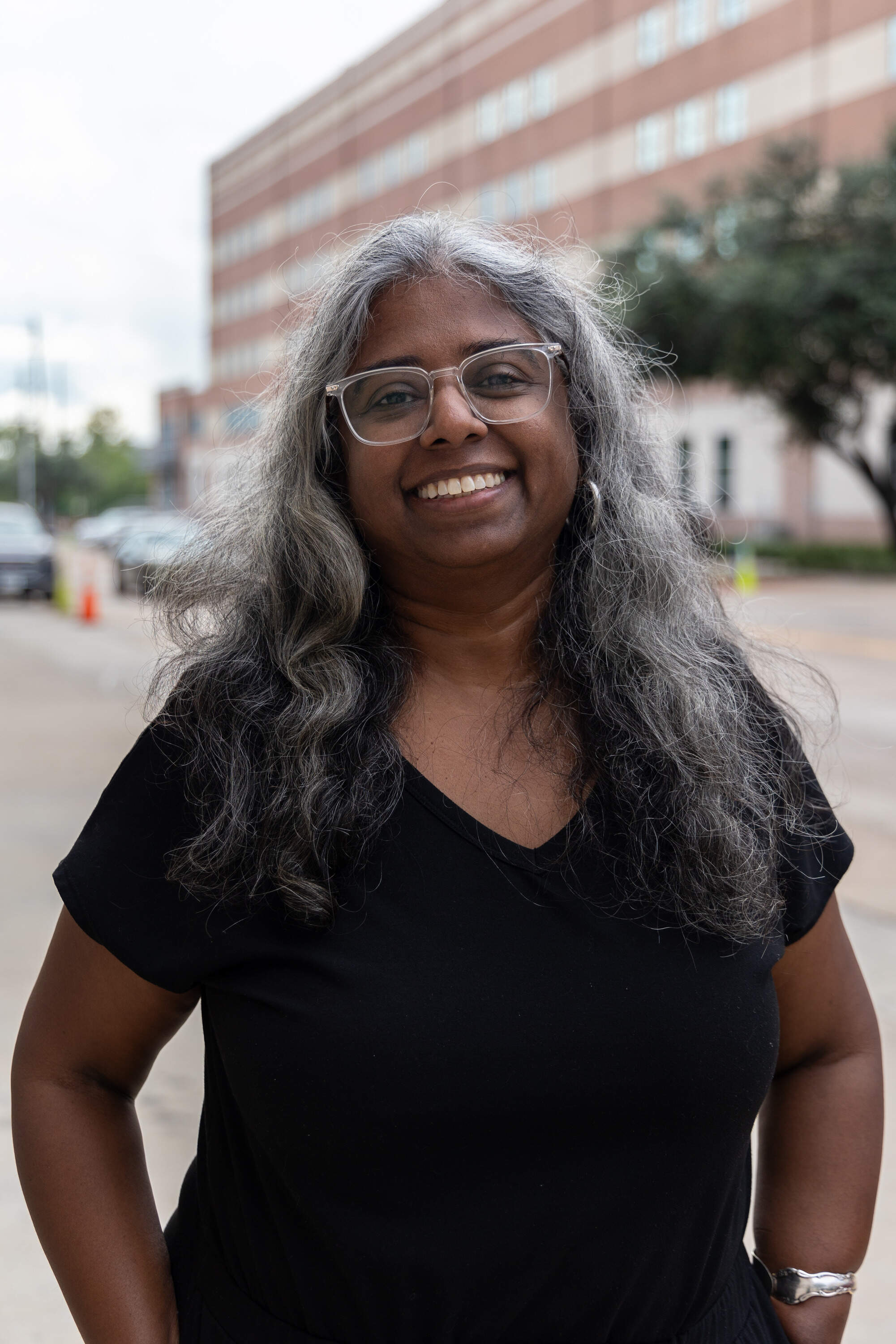 Krish Gundu and her colleagues stop people who have spent the night in the prison processing center as they walk out the door. (Lucio Vasquez/Here & Now)