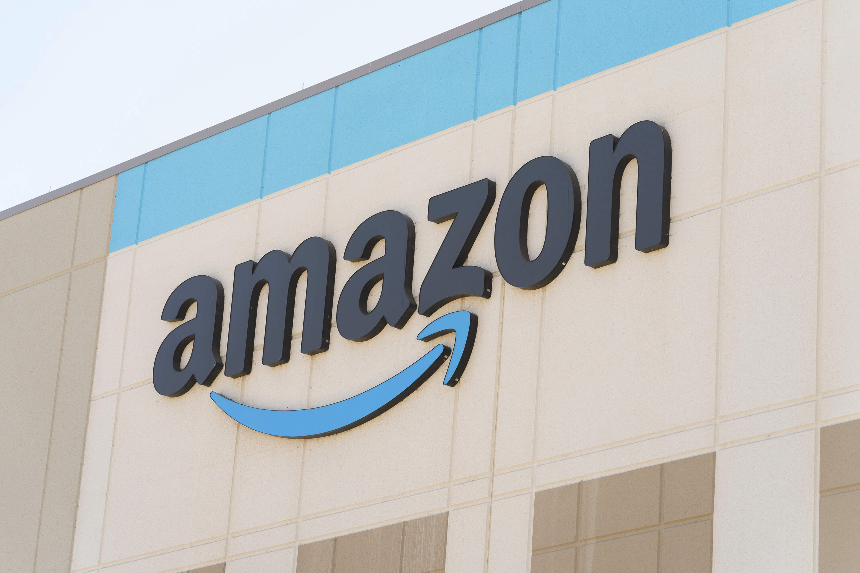 The Amazon logo is seen on the exterior wall of the Amazon OXR1 fulfillment center in Oxnard, California. (Damian Dovarganes/AP)