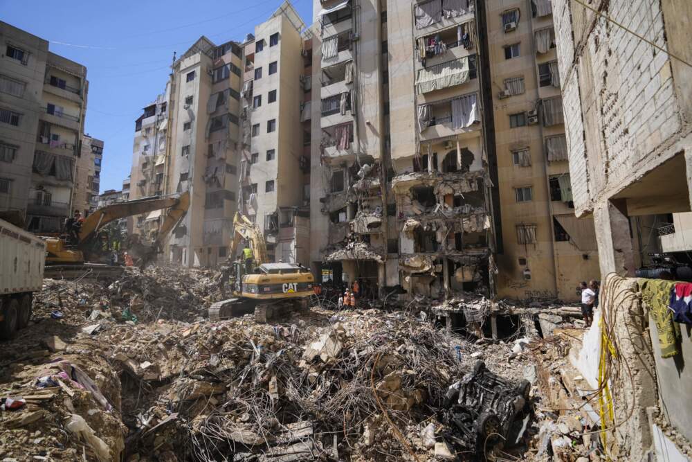 Emergency workers use excavators to clear the rubble at the site of Friday's Israeli strike in Beirut's southern suburbs, Lebanon, Monday, Sept. 23, 2024. (Hassan Ammar/AP)