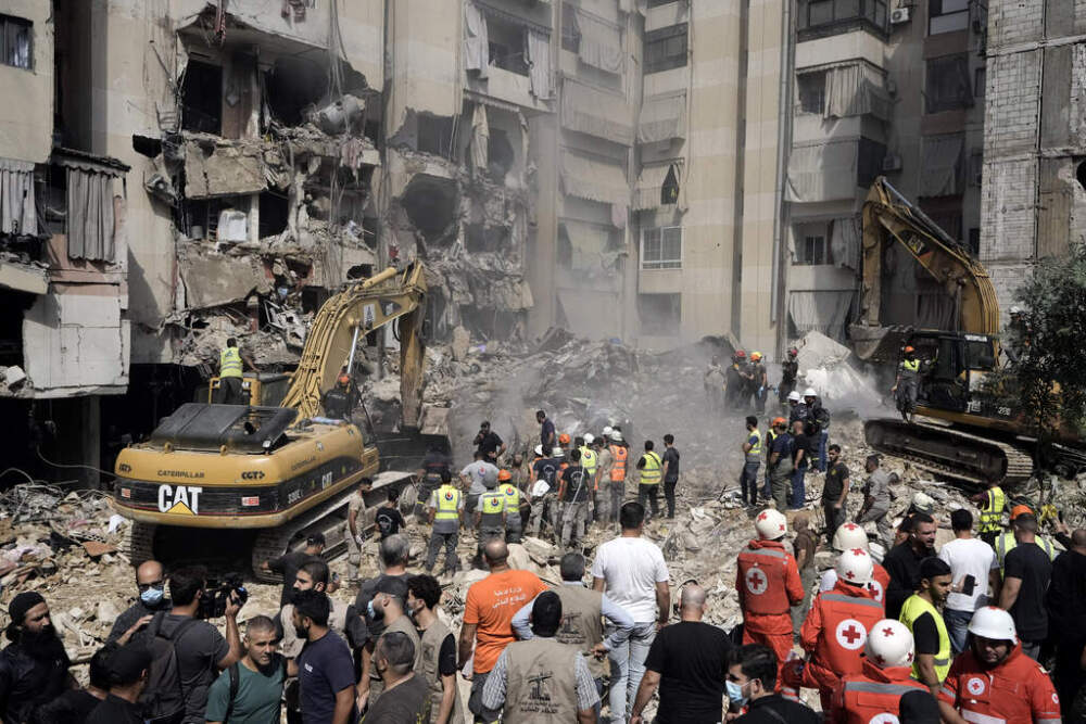 Emergency workers use excavators to clear the rubble at the site of Friday's Israeli strike in Beirut's southern suburbs, Saturday, Sept. 21, 2024. (Bilal Hussein/AP)