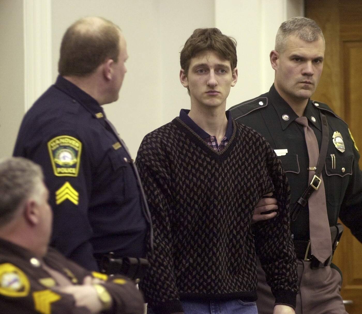 Robert Tulloch, then 17, is escorted into Lebanon, N.H. District Court, Feb. 21, 2001. (Jim Cole/AP)