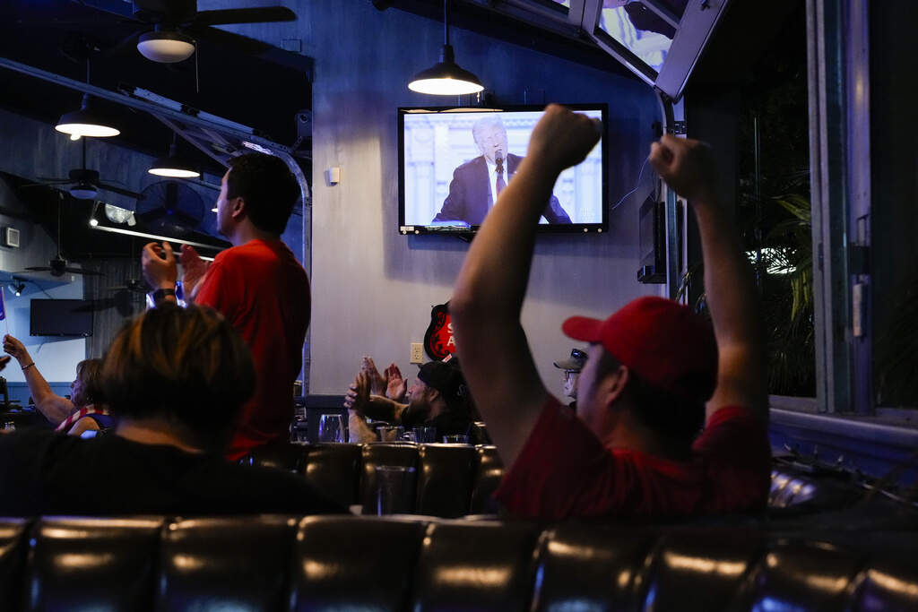 Supporters watch Republican presidential candidate former President Donald Trump speak at the Republican National Convention on a television Thursday, July 18, 2024, in Seal Beach, Calif. (AP Photo/Ashley Landis)