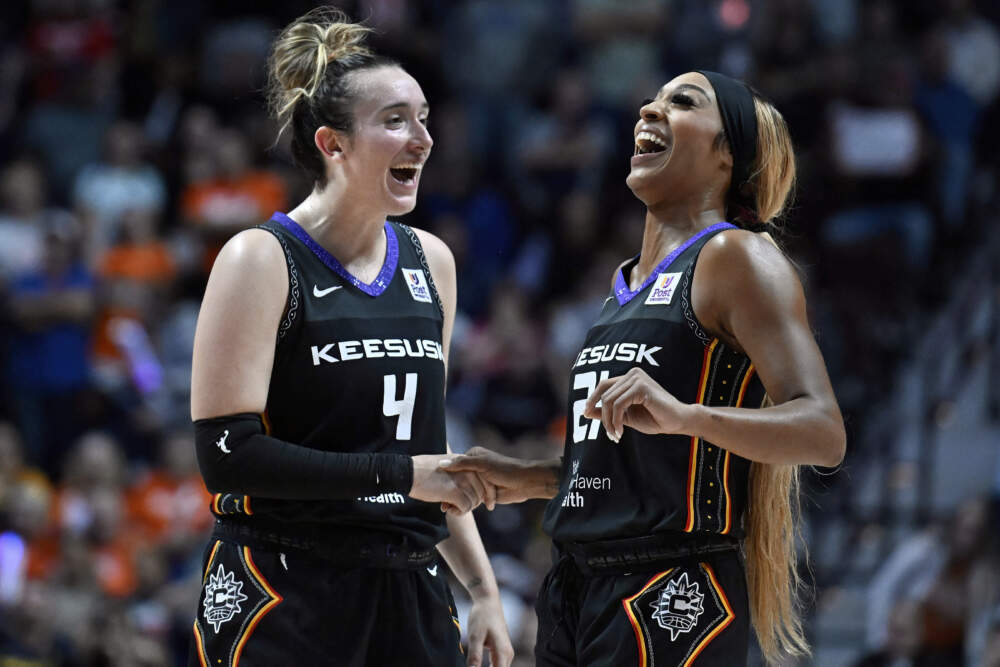 Connecticut Sun guards Marina Mabrey (4) and DiJonai Carrington (21) celebrate together during the second half of a first-round WNBA basketball playoff game against the Indiana Fever, Wednesday, Sept. 25, 2024, in Uncasville, Conn. (Jessica Hill/AP)