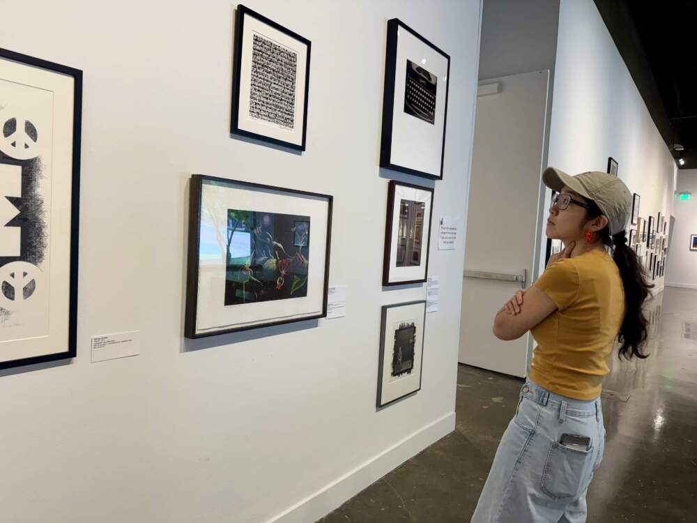 Ina Wu, an architecture student, contemplates which work to take home. (By Maddie Browning)