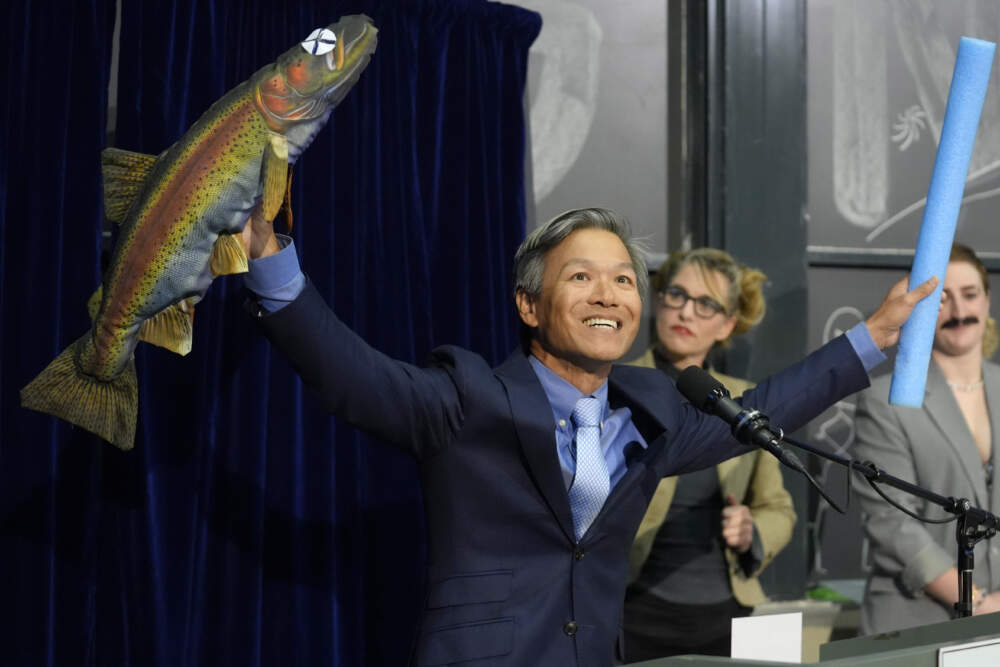 Professor James Liao presents a stuffed fish while accepting a physics award for demonstrating and explaining the swimming abilities of a dead trout. (Steven Senne/AP)