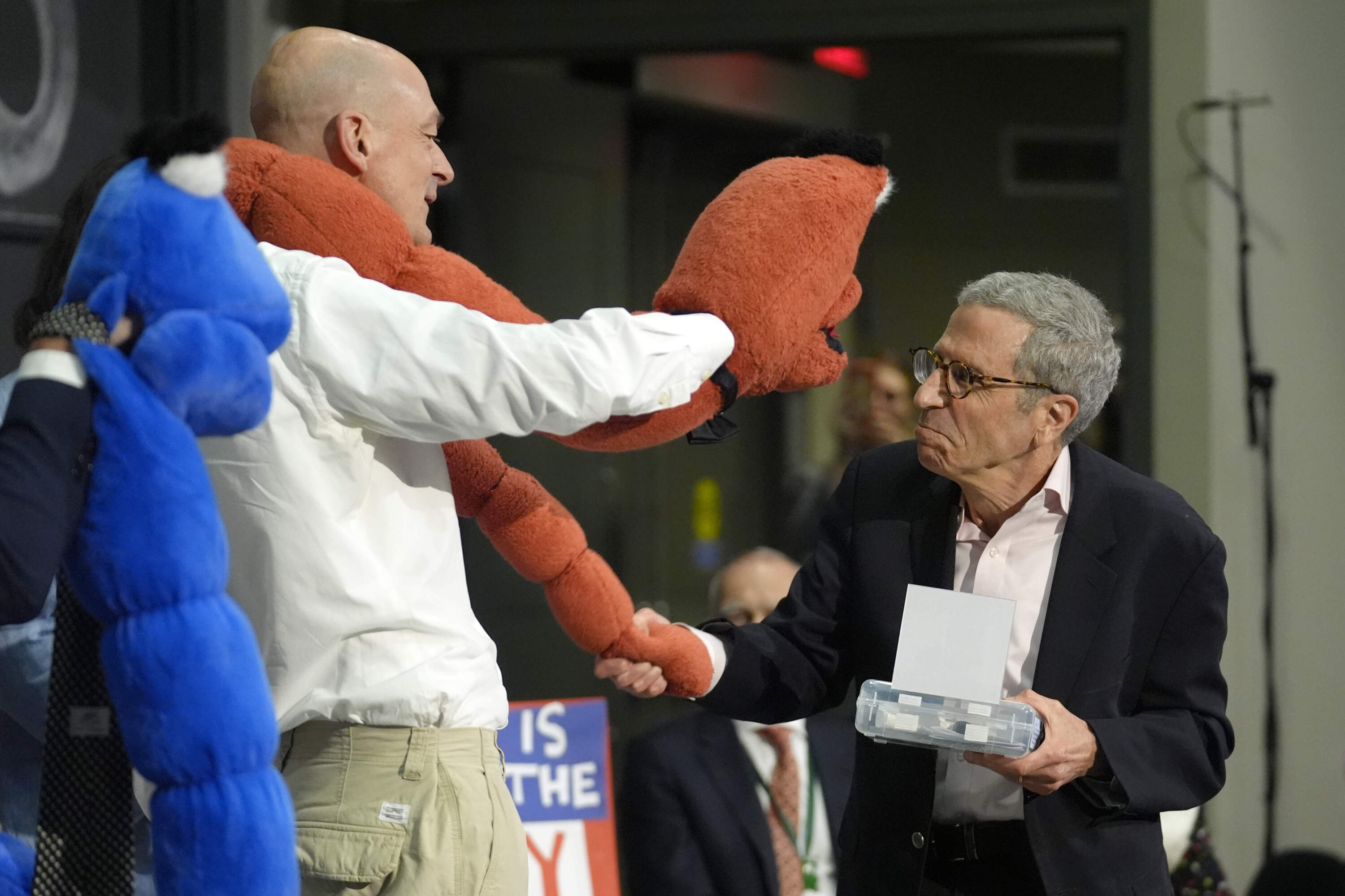 Eric Maskin, 2007 Nobel Laureate in Economics, right, presents an Ig Nobel award to a members of a team of researchers who who used chromatography to separate drunk and sober worms, Thursday, Sept. 12, 2024. (Steven Senne/AP)