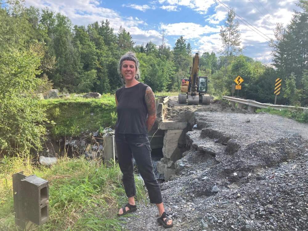 Stannard Select Board member Katy Knuth, seen here standing in front of a washed-out bridge on Stannard Mountain Road is still waiting on reimbursement from FEMA for the cost of repairing damage to roads and other public infrastructure. (Peter Hirschfeld/Vermont Public)