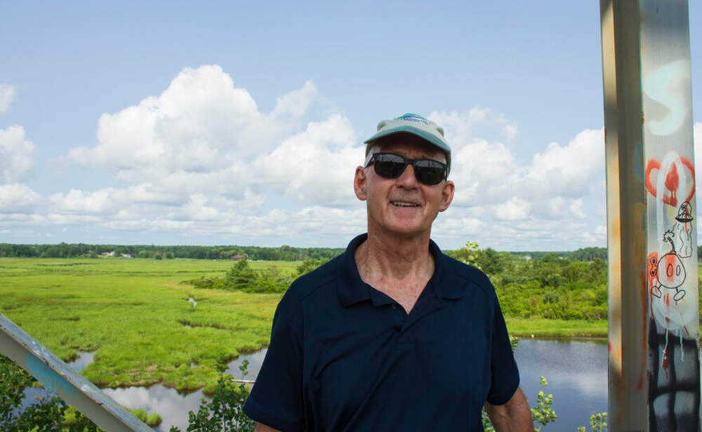 Scarborough Land Trust board member Steve Pinette stands in an observation tower off Route 1. (Annie Ropeik/ The Maine Monitor)